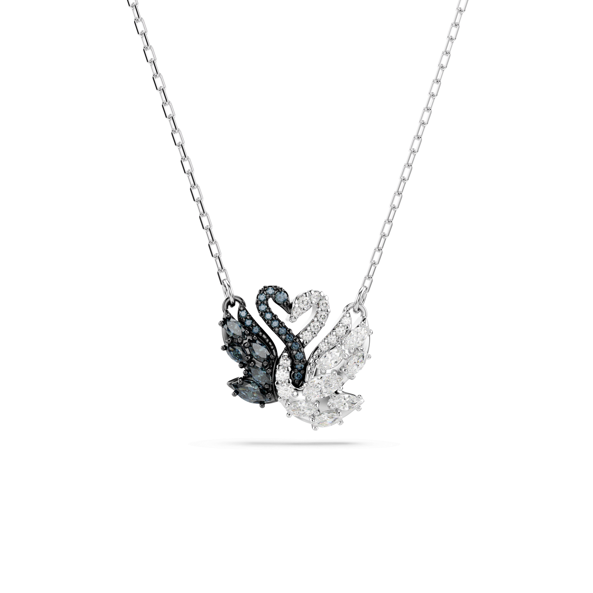 Introducing the Swarovski Swan Pendant: this elegant necklace features a pendant shaped like two swans forming a heart—one side adorned with sparkling black stones, the other with clear stones. Finished with mixed metals for enduring shine, this beautiful piece by Swarovski captures timeless romance and sophistication in every detail.