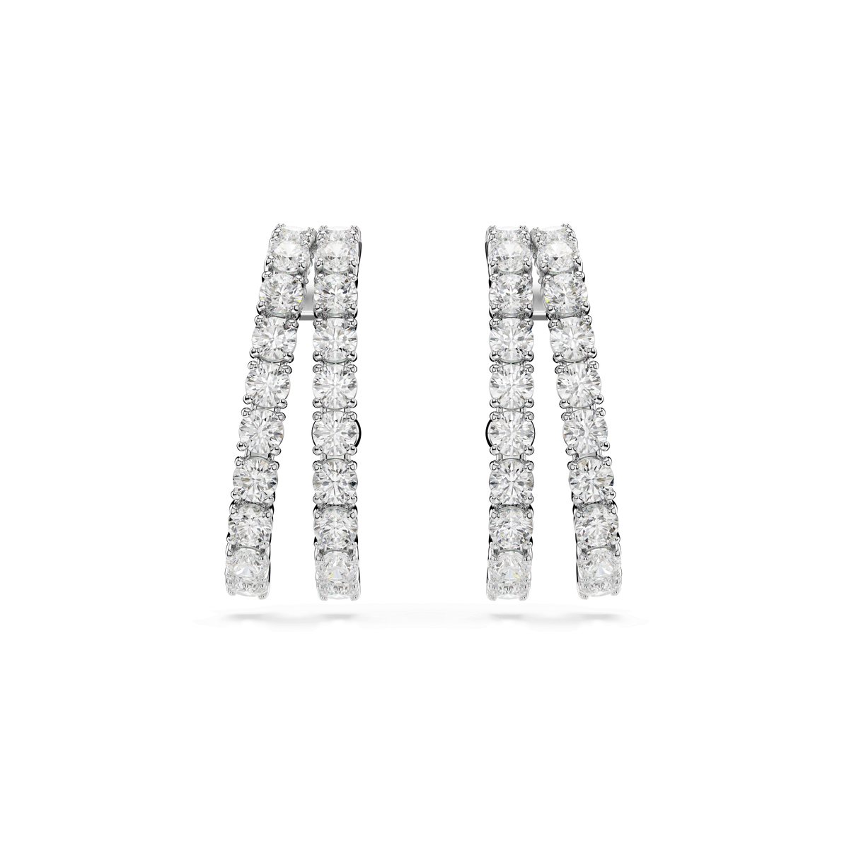 A pair of Swarovski Matrix ear cuffs by Swarovski, featuring a silver double-row hoop design encrusted with sparkling white gemstones, displayed on a plain white background.