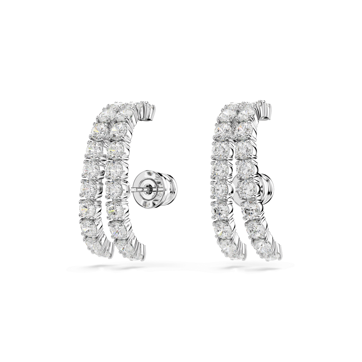 Introducing the Swarovski Matrix ear cuffs by Swarovski—a pair of silver earrings featuring two parallel rows of round, sparkling crystals in a gracefully curved design with secure stud backings. Exclusively available at Raffi Jewellers, these elegant earrings are showcased against a plain white background.