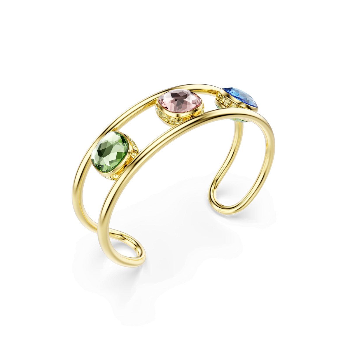 Introducing the Swarovski Chroma cuff, a stunning gold-tone plated open cuff bracelet by Swarovski. This elegant piece showcases three large, cushion-cut round gems—each in vibrant green, pink, and blue—individually set along sleek double gold bands. Inspired by the Chroma collection from Swarovski Canada, it radiates modern elegance and bold color.