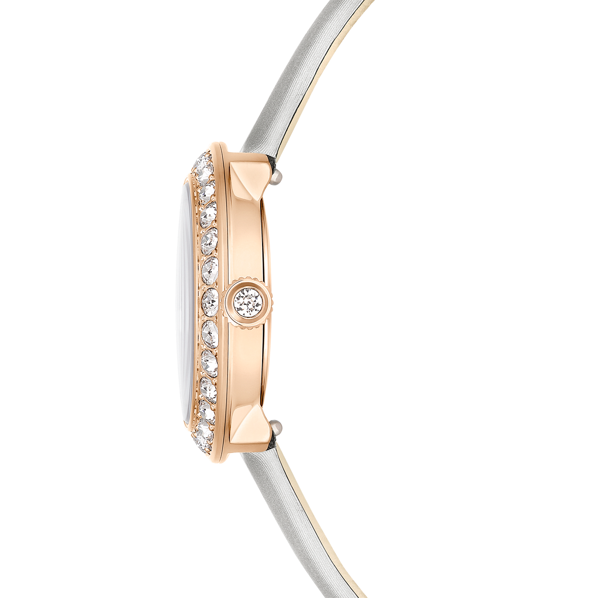 Side view of the Swarovski Matrix Tennis Quartz Watch featuring a slim, rose gold PVD 30MM case with embedded clear stones along the edge, paired with a thin, light gray leather bracelet strap.