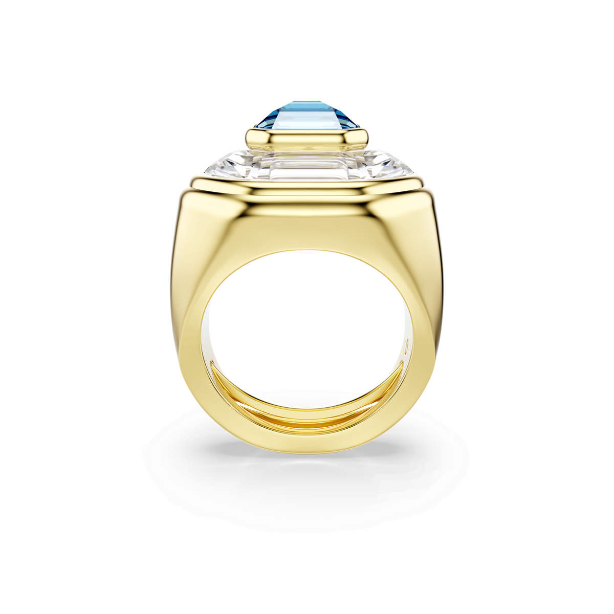 The Swarovski Chroma cocktail ring, featuring an octagon-cut blue stone set on a thick gold-tone plated band with sparkling clear side stones, is displayed from the side against a plain white background. This sophisticated statement piece by Swarovski exemplifies elegance and style.