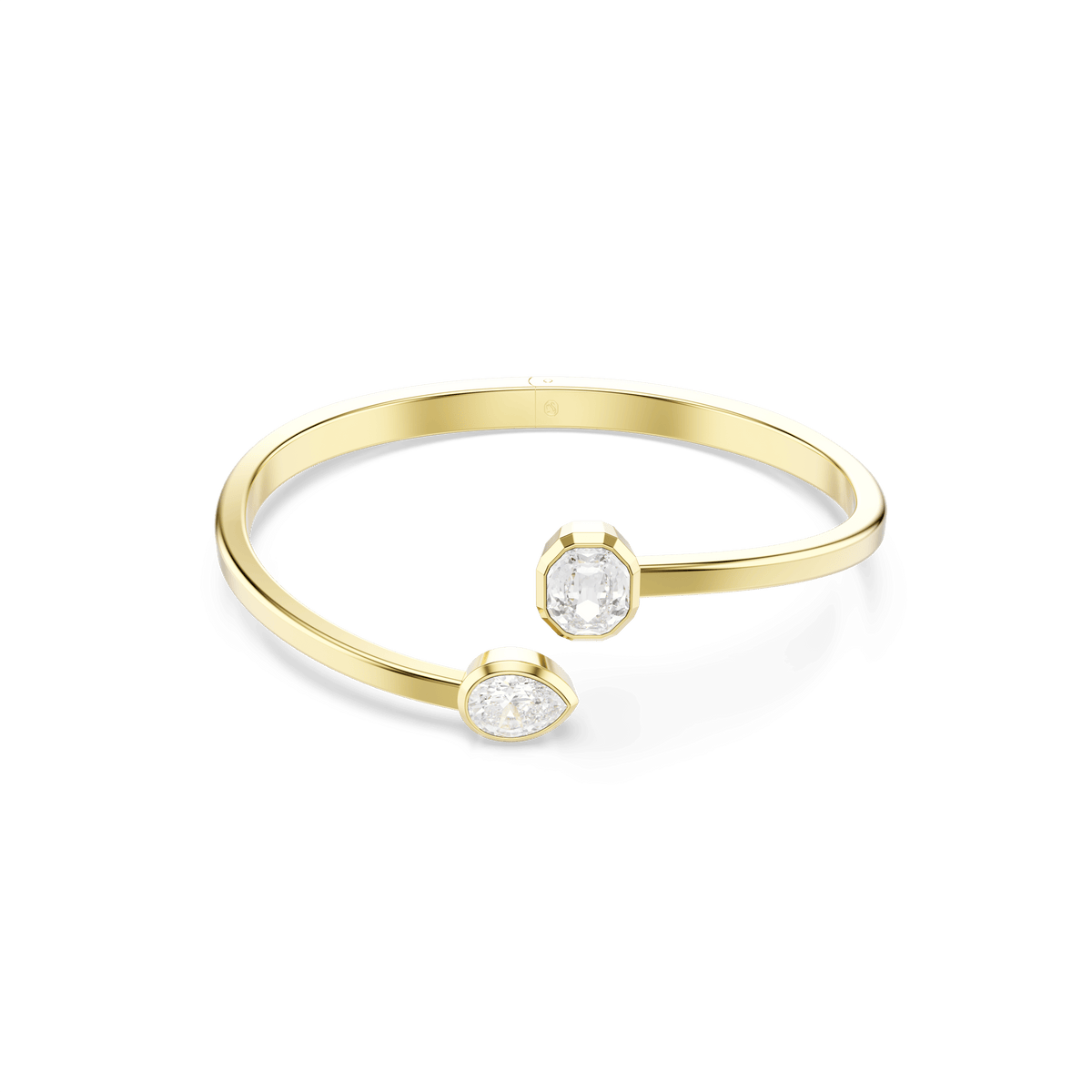 The Swarovski Imber bangle is a luxurious 18K gold-finished open bracelet by Swarovski, featuring two bezel-set white Swarovski Zirconia gemstones in mixed cuts—one round and one oval—accenting each open end, showcased against a plain white background.