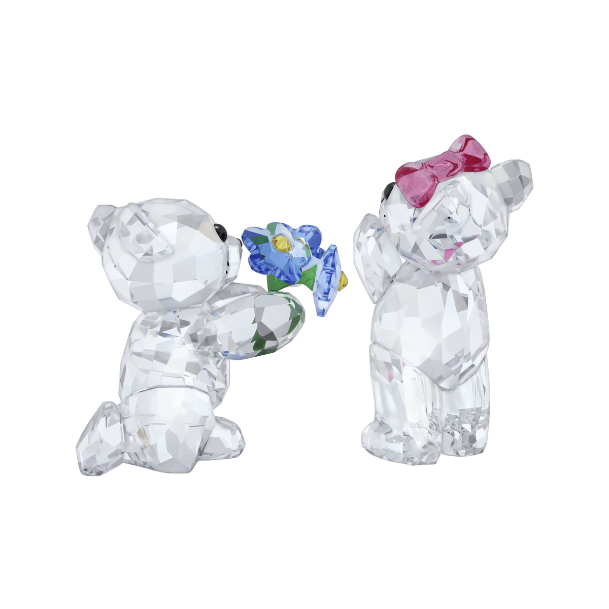 The Swarovski Kris Bear I Adore You set by Swarovski features two clear, faceted crystal figurines: one bear kneeling with a blue flower and the other standing with a pink bow. Posed together against a plain white background, this charming duo makes an ideal romantic gift or addition to any collectible crystal figurine collection.