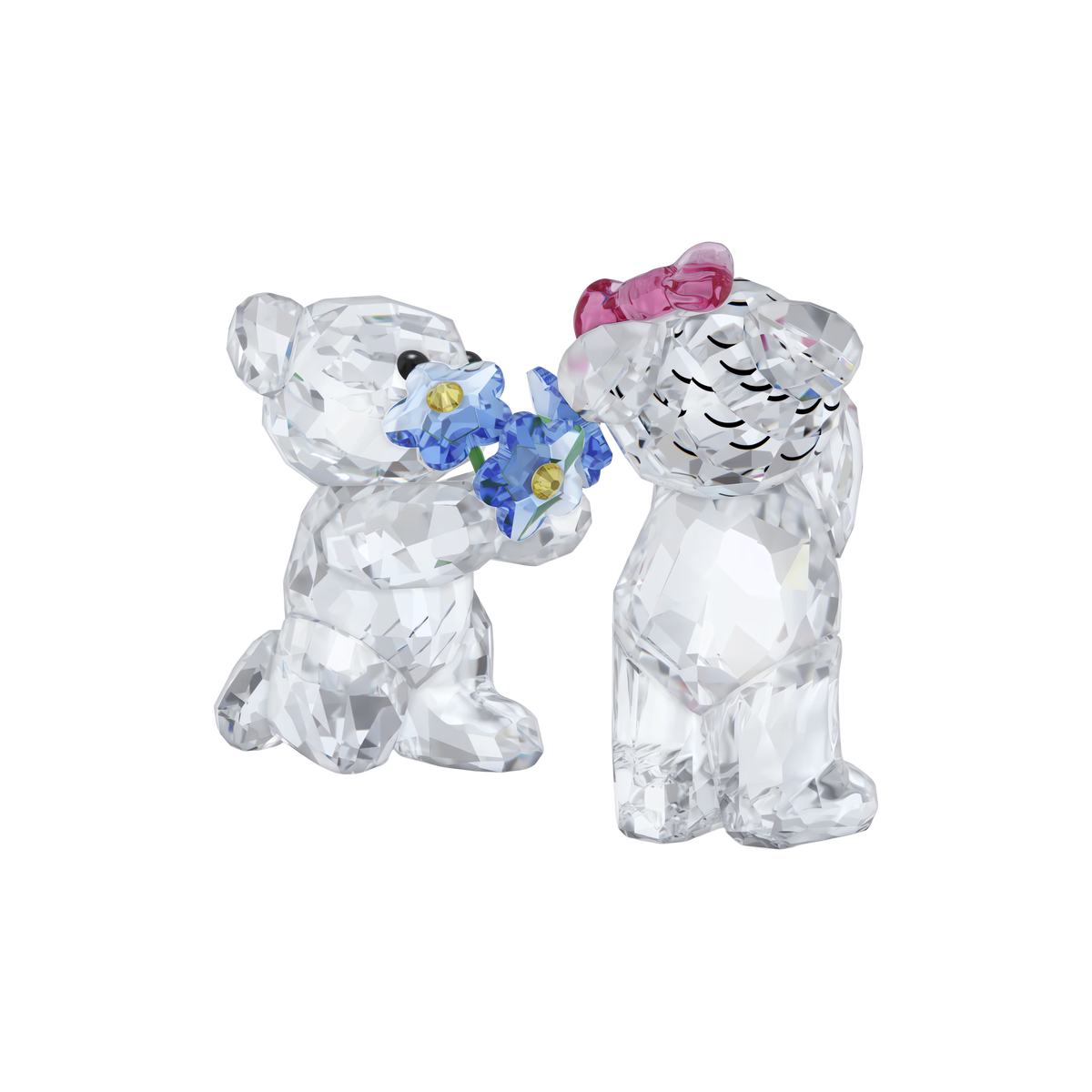 Gift the Swarovski Kris Bear I Adore You figurines: one bear kneels to present delicate blue flowers, while the other stands with a pink bow, bashfully accepting—a delightful and romantic Swarovski gift for someone special.