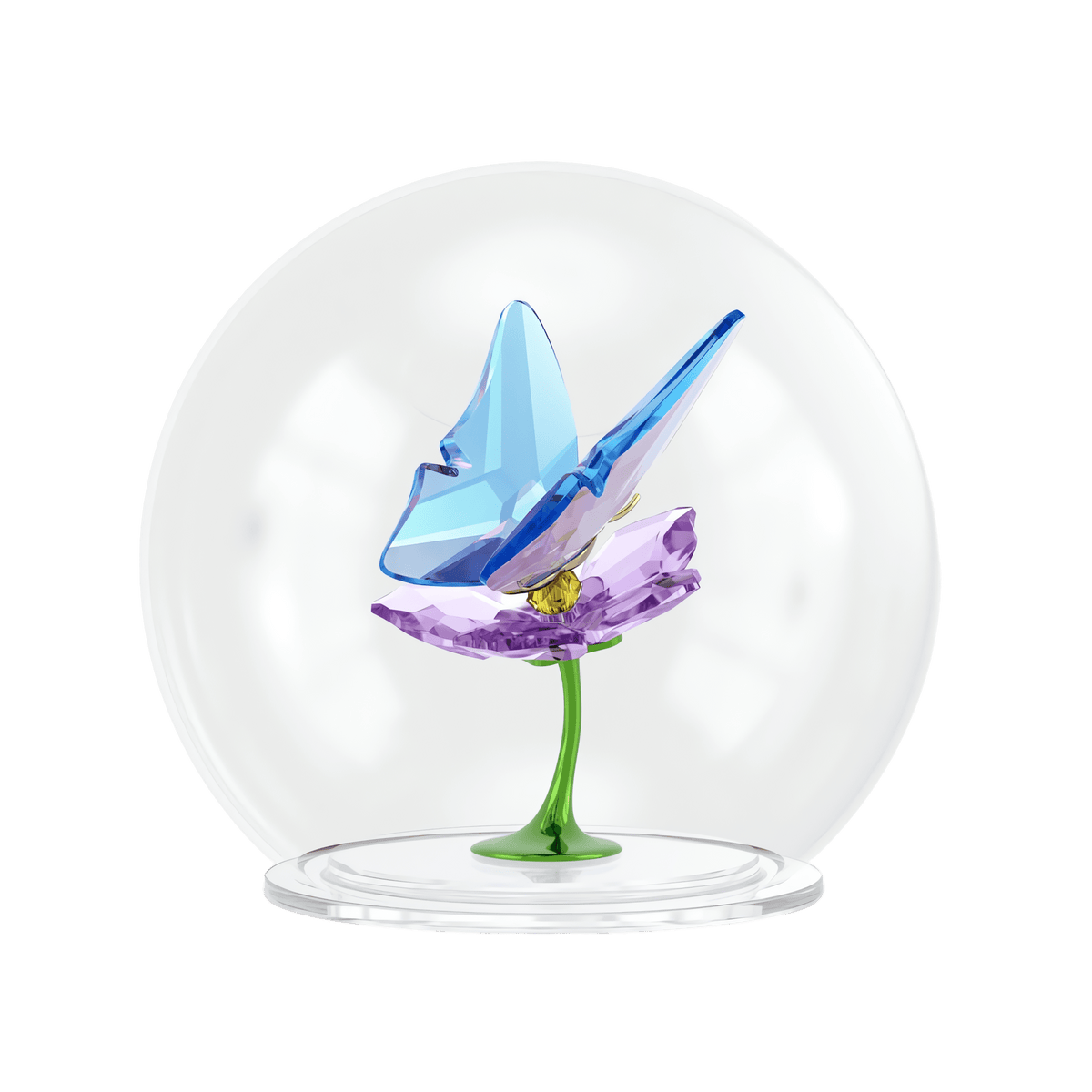 Introducing the Swarovski Idyllia Glass Ball Butterfly and Flower by Swarovski—a stunning collectible decoration featuring a vibrant blue butterfly delicately poised on a purple flower with an elegant green stem. This exquisite piece is beautifully encased within a clear glass dome atop a round base, making it a perfect addition to any glass ball creation collection.