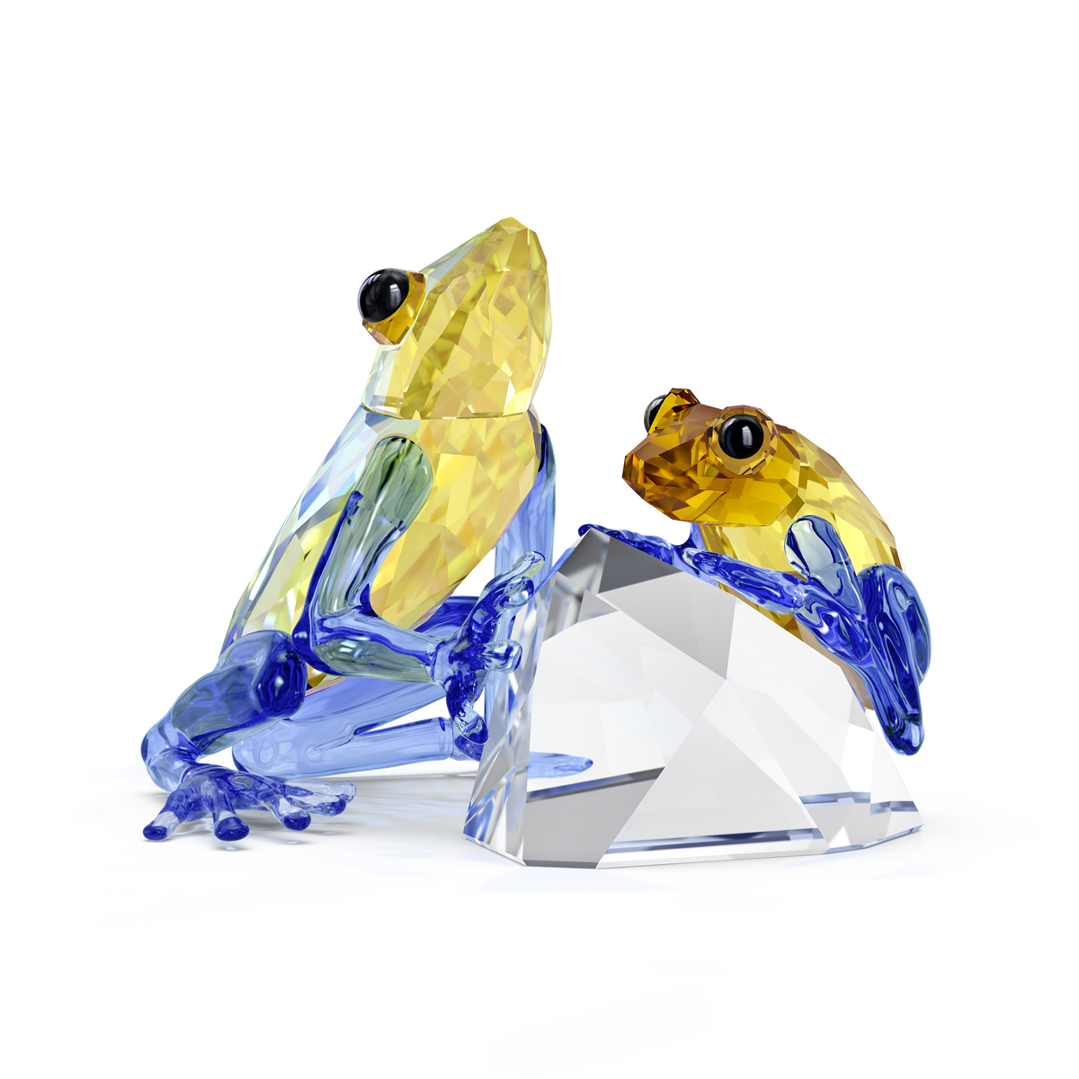 Swarovski’s Idyllia Frog and Baby figurine features two crystal glass frogs—a larger parent and a smaller baby—resting beside a clear crystal rock on a white background. Their yellow and blue bodies, accented by shiny black eyes, showcase exquisite detail and artistry. This charming piece beautifully captures the essence of parental love, making it an elegant home decoration from Swarovski.