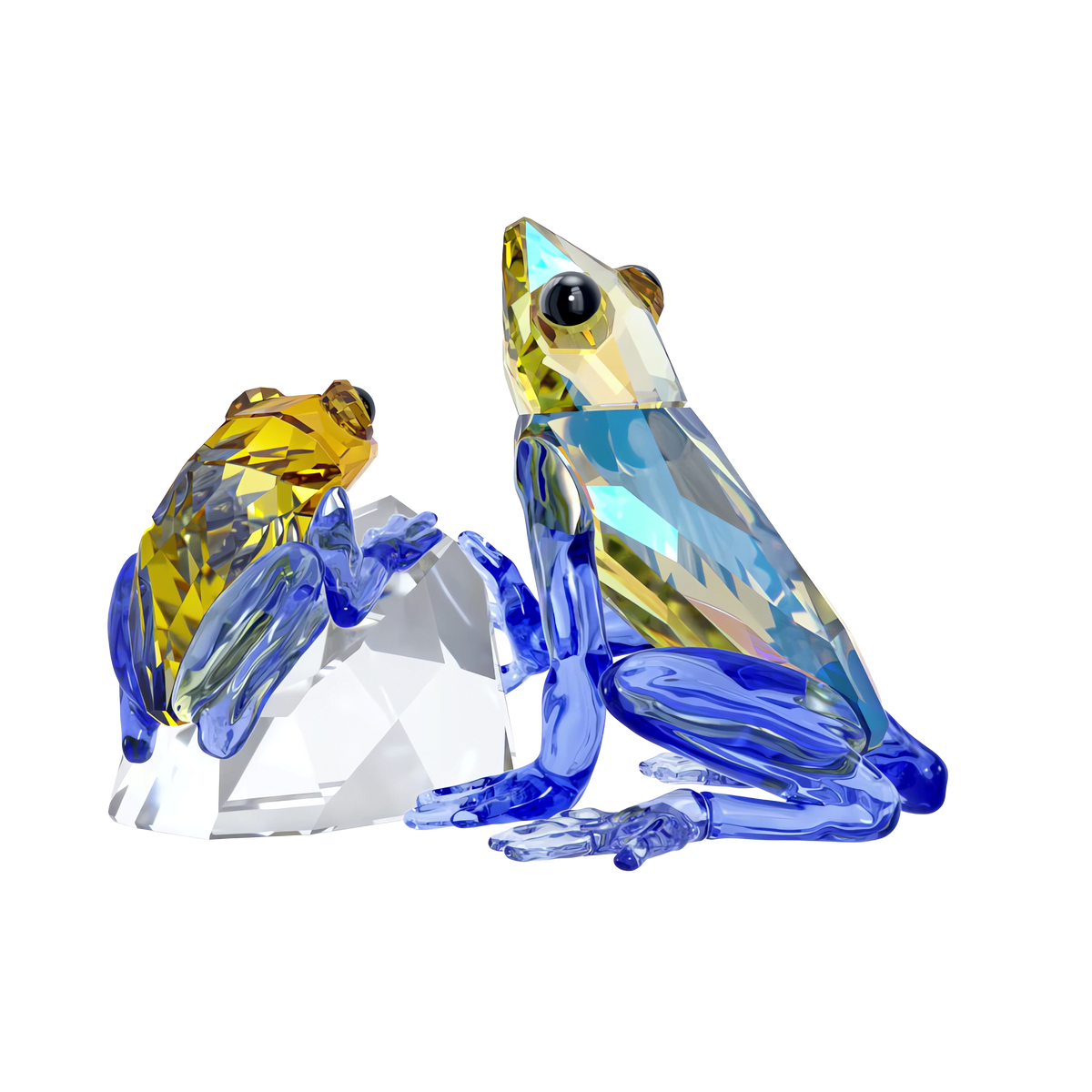 The Swarovski Idyllia Frog and Baby by Swarovski features a yellow and a blue faceted crystal frog perched on a clear crystal rock. Both frogs have blue legs, black eyes with smooth reflective surfaces, and are beautifully displayed against a plain white background. This elegant figurine captures the essence of parental love, making it a charming addition to any home décor.