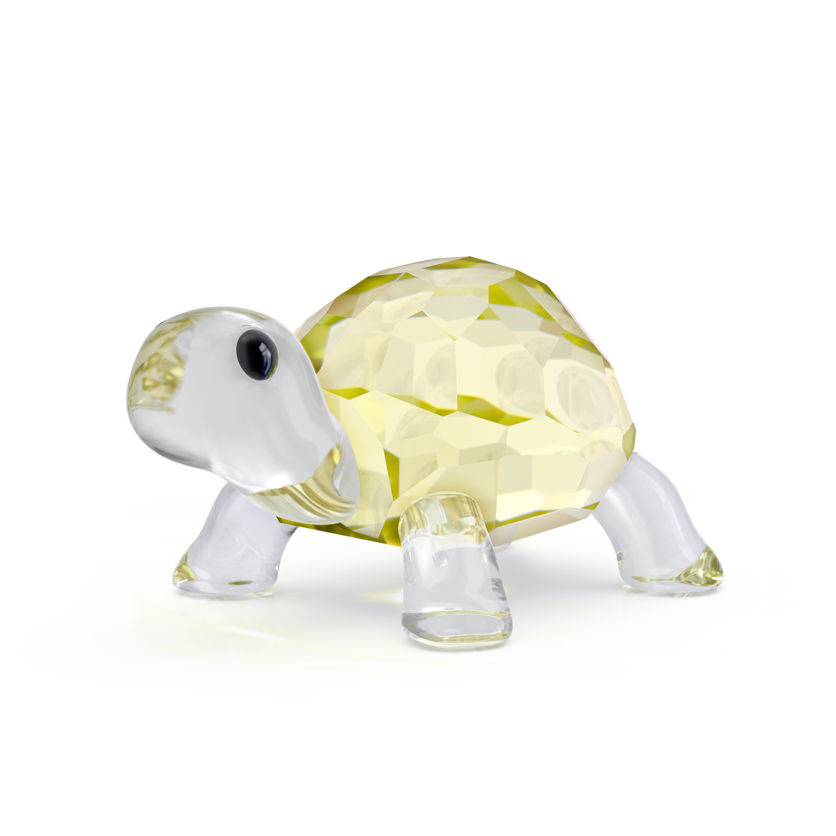 The Swarovski Idyllia Baby Tortoise by Swarovski is a charming nature figurine, featuring a faceted yellow shell with clear crystal legs, head, and tail, displayed on a plain white background. This delightful crystal décor piece makes a perfect baby tortoise decoration for any space.