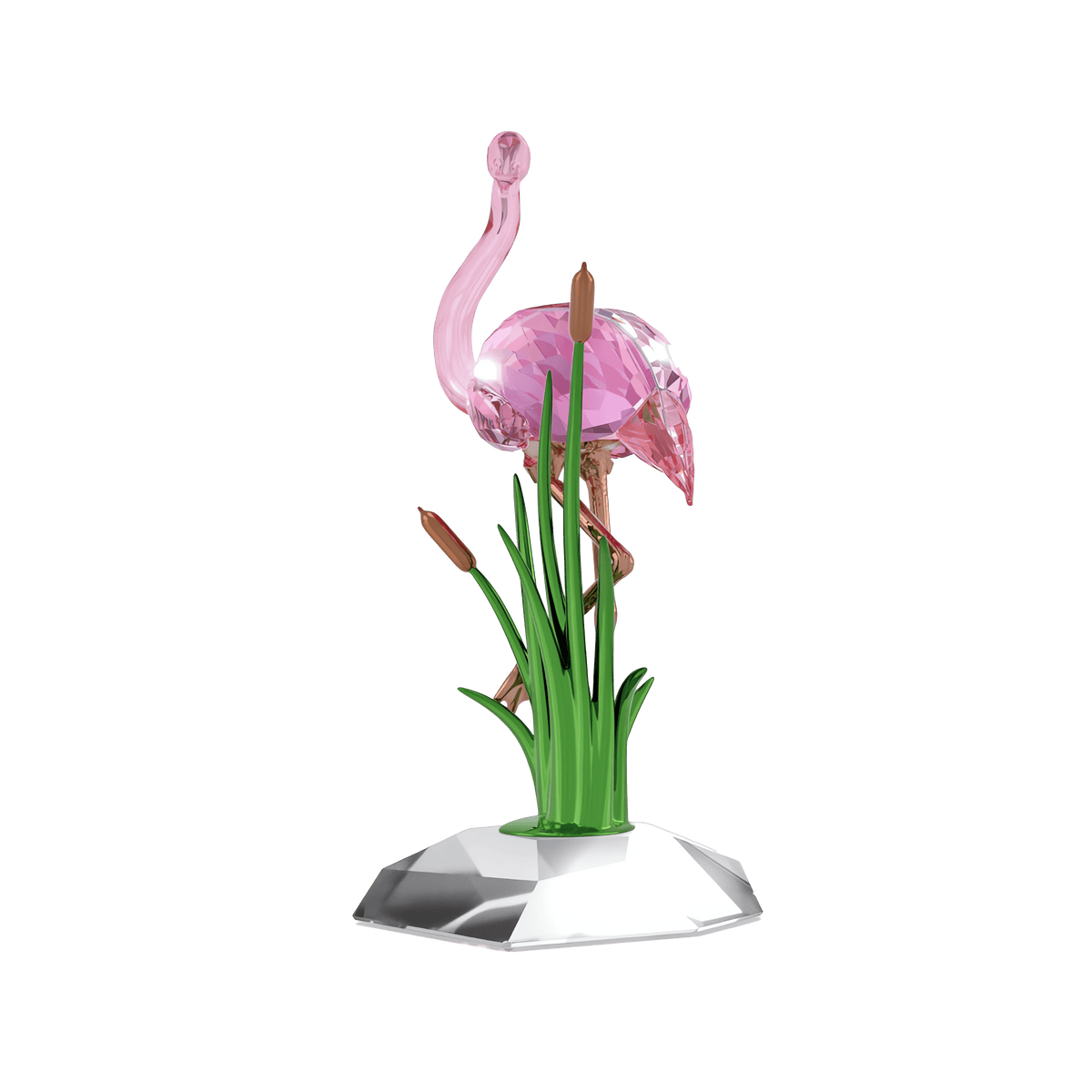 The Swarovski Idyllia Flamingo by Swarovski features a rose gold-tone flamingo figurine standing on a faceted base, surrounded by green glass reeds and brown cattails against a plain white background—an elegant decorative piece that brings charm to any space.