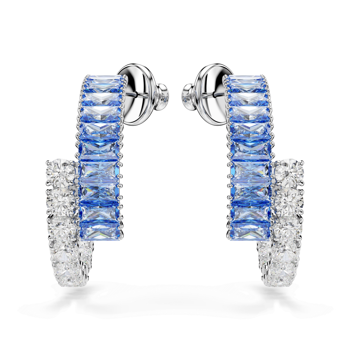 A pair of Swarovski Matrix hoop earrings, featuring mixed cuts of blue and clear gemstones and finished with a lustrous blue rhodium plating, is displayed against a plain white background.