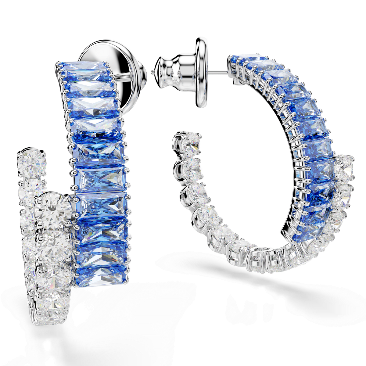 The Swarovski Matrix hoop earrings by Swarovski feature mixed cuts with alternating rectangular blue and round clear gemstones, elegantly set in rhodium-plated metal and showcased against a white background.