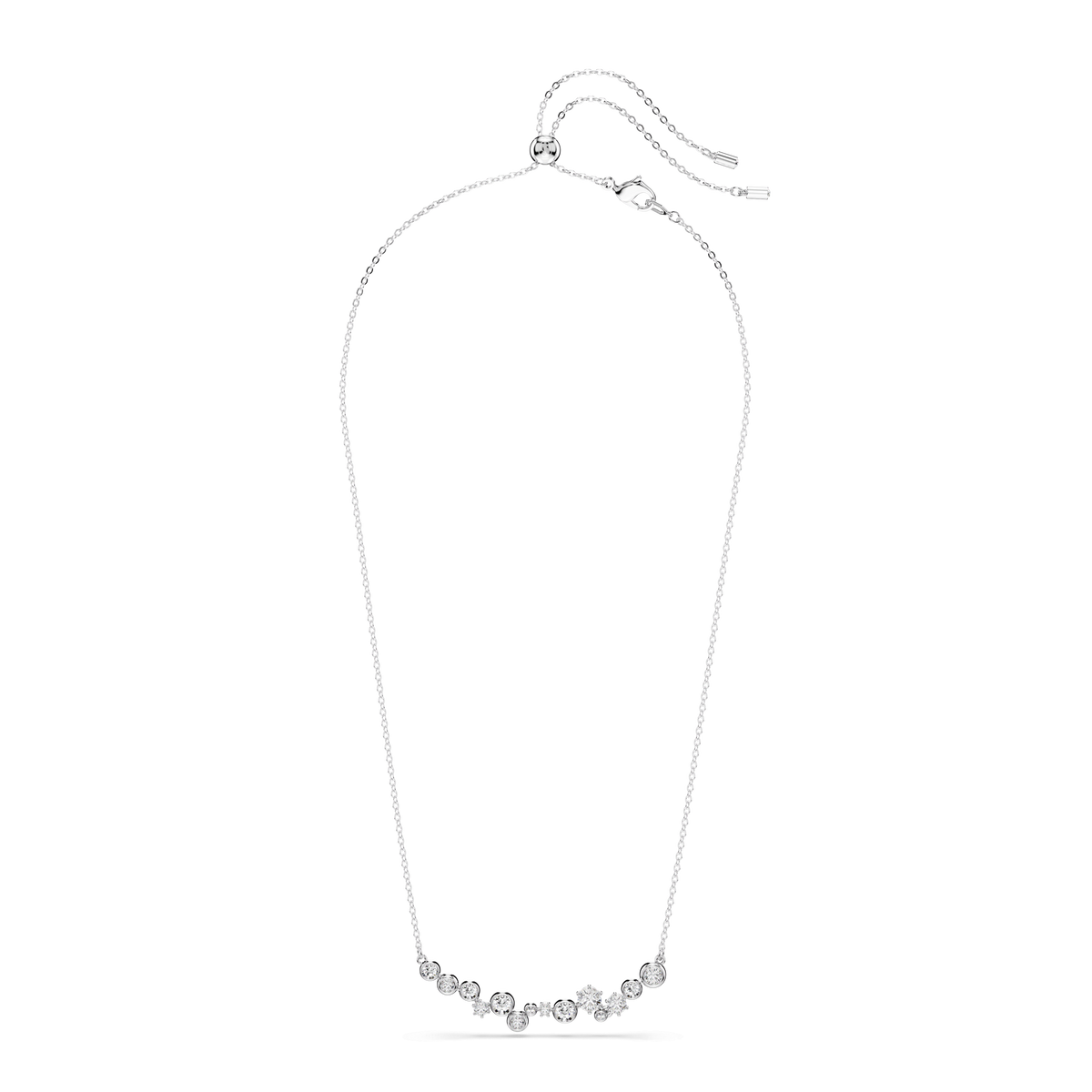 The Swarovski Constella necklace features mixed-cut white crystals set on an adjustable rhodium-plated chain, offering enhanced shine and durability. The small, clear stones are evenly spaced along the lower front of this delicate silver piece by Swarovski, shown against a plain white background.