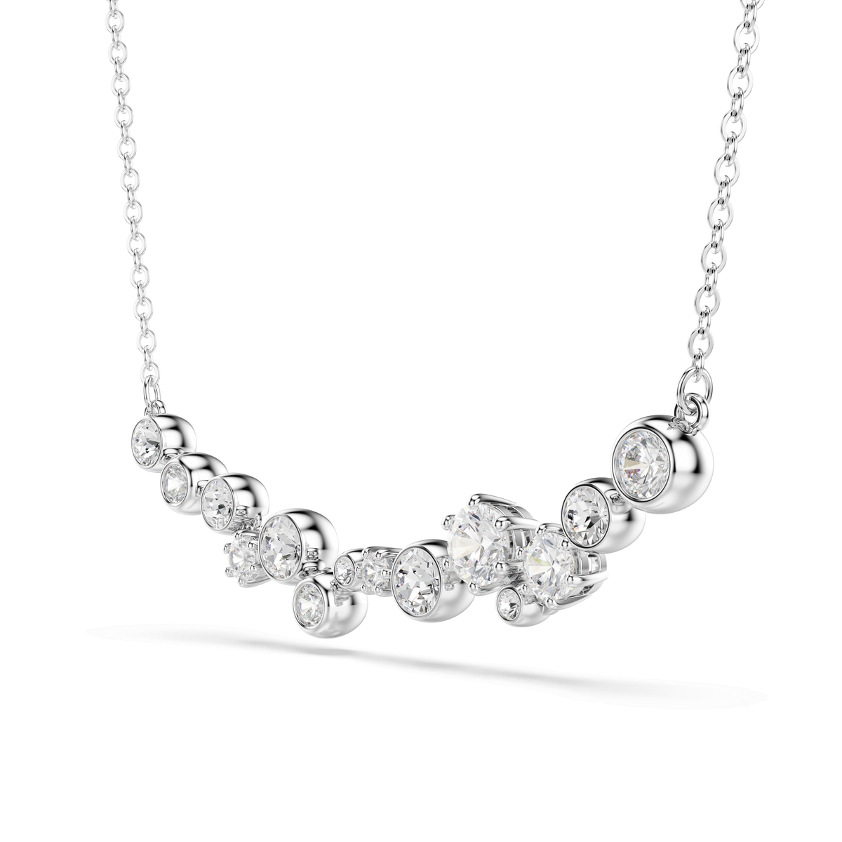 The Swarovski Constella necklace showcases mixed-cut white crystals in round and oval shapes, arranged in an elegant curved row along a delicate chain and finished with luminous rhodium plating.