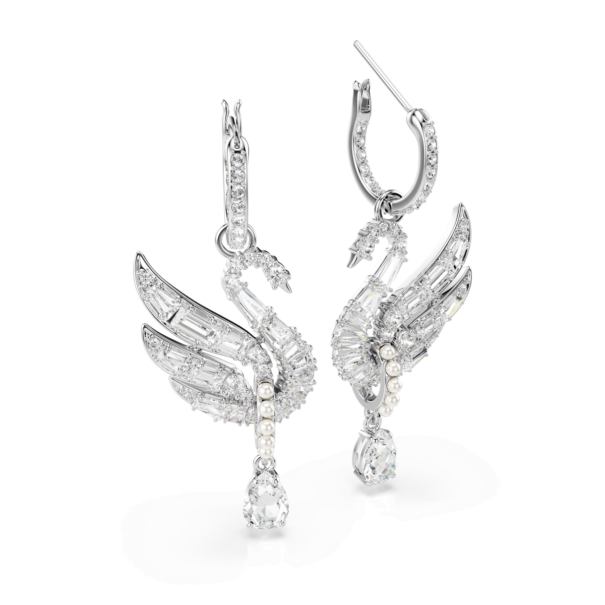 A pair of Swarovski Swan earrings in white with rhodium plating, featuring detailed swan designs adorned with clear gemstones and small Swarovski Crystal Pearls, cascading teardrop-shaped stones from the wings, presented against a plain white background.