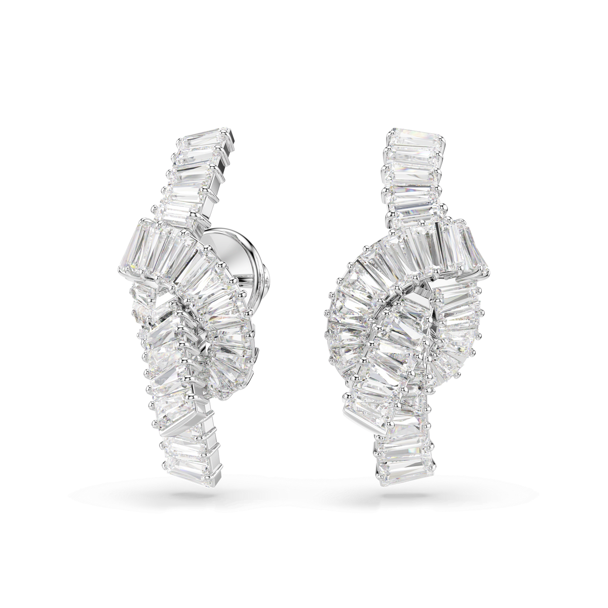 The Swarovski Matrix earrings, featuring a striking knot design with baguette-cut white Swarovski Zirconia and a rhodium-plated finish, are displayed against a plain white background.