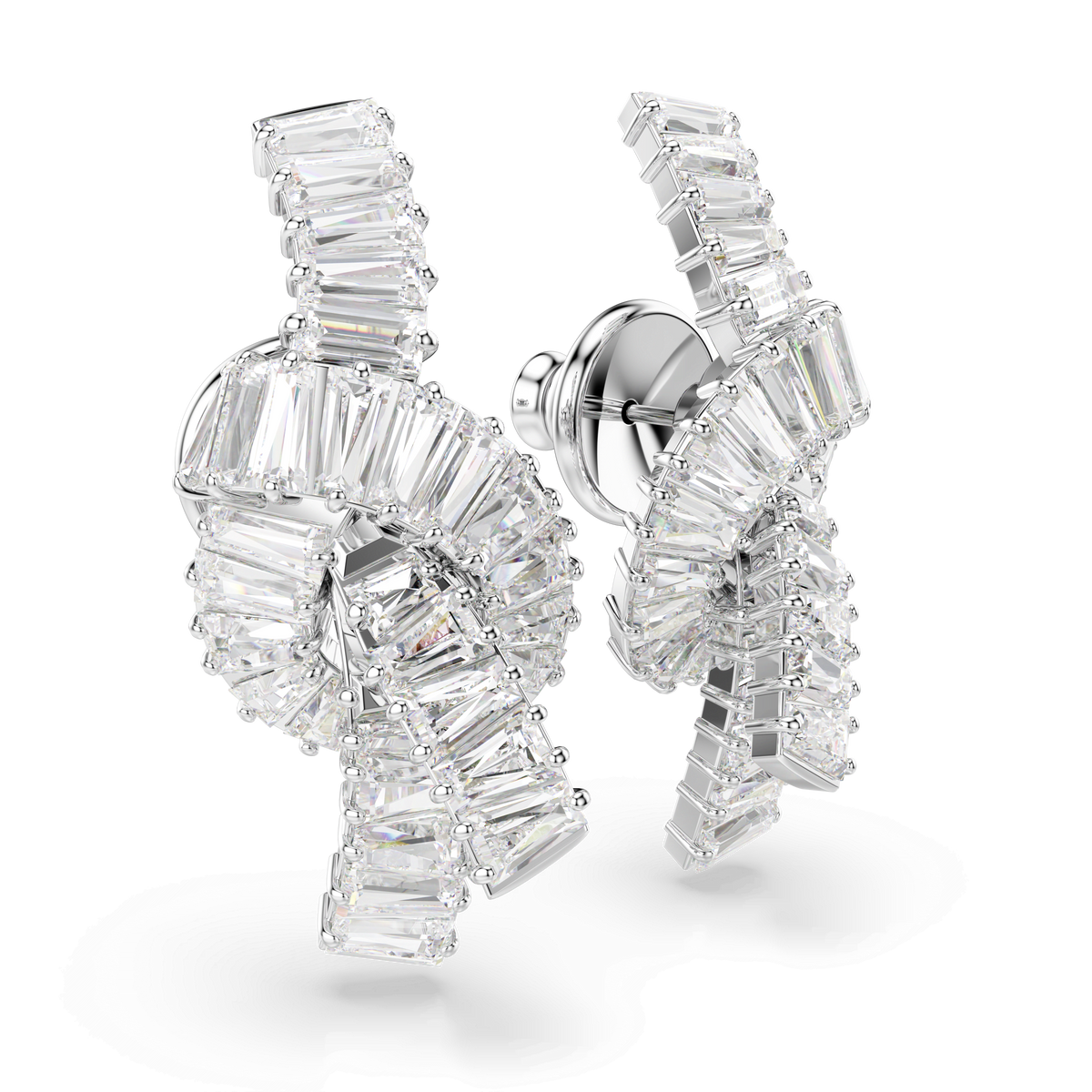 A pair of Swarovski Matrix earrings in a knot design, featuring baguette-cut white Swarovski Zirconia set in lustrous rhodium-plated backing, showcased against a white background.