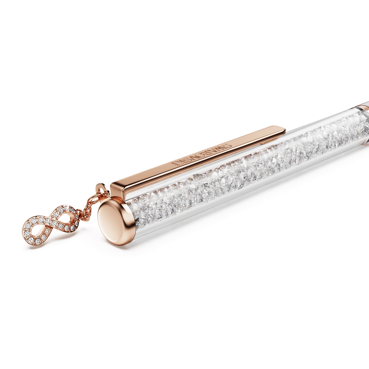 The Swarovski Crystalline ballpoint pen, Infinity, features elegant pink lacquer, rose gold-tone plating, and a clear barrel filled with sparkling crystals. Adorned with an infinity symbol charm encrusted with small gems and crafted in the signature Swarovski style, this luxurious slimline pen is perfect for adding a touch of glamour to your writing.