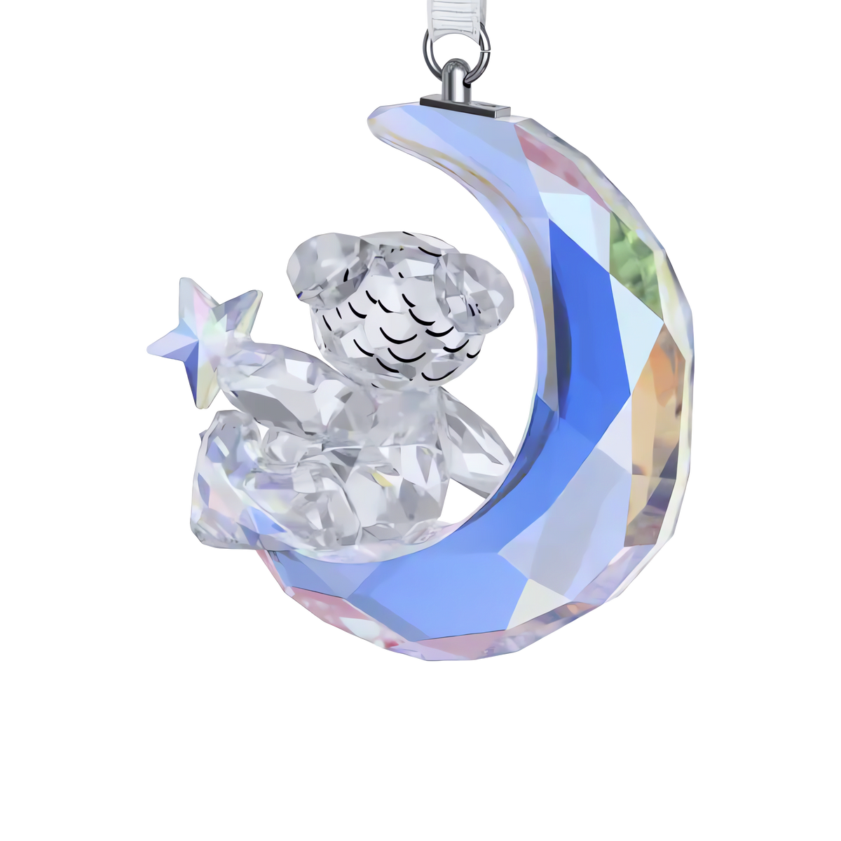 The Swarovski Kris Bear Moon Ornament by Swarovski features a faceted glass teddy bear holding a star while seated on a crescent moon, shimmering with iridescent blue and rainbow reflections—this enchanting design is inspired by the beloved Kris Bear ornament collection.