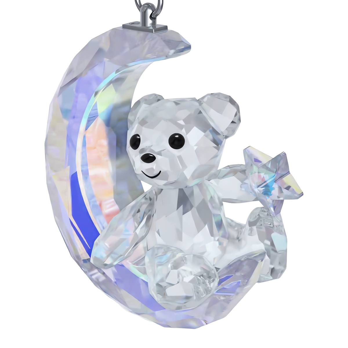The Swarovski Kris Bear Moon Ornament from Swarovski showcases a delightful Kris Bear holding a star, elegantly perched on a crescent moon and shimmering with iridescent colors.