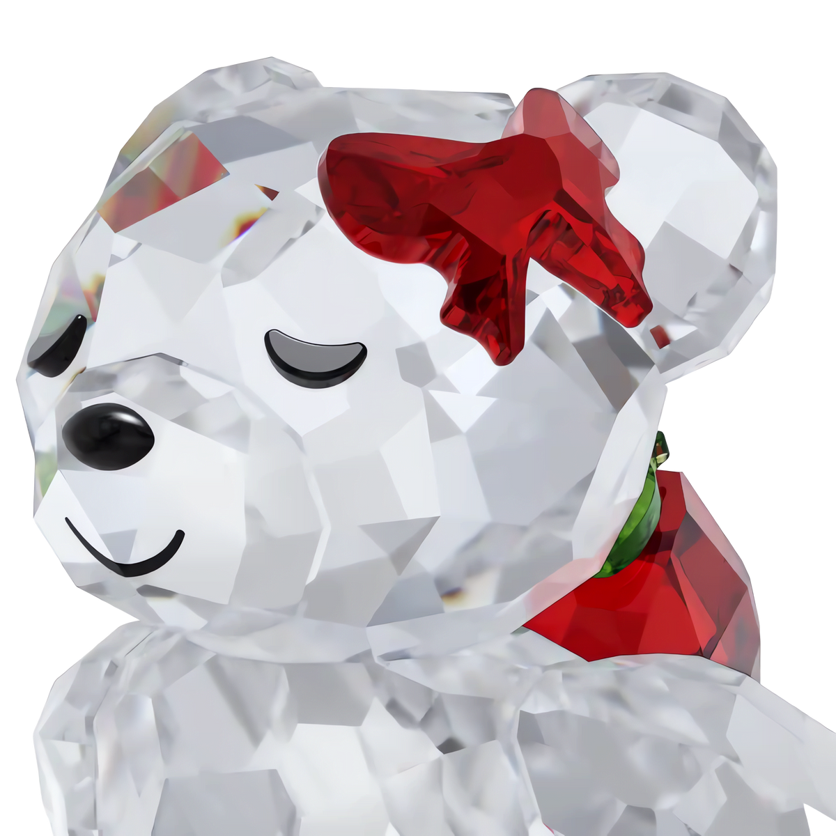 Swarovski Kris Bear Holiday Annual Edition 2026 features a charming crystal bear figurine with closed eyes, a gentle smile, and a red crystal bow on its ear. This delightful piece from Swarovski appears translucent and reflective against a plain background, making it perfect for adding sparkle to any Swarovski display.