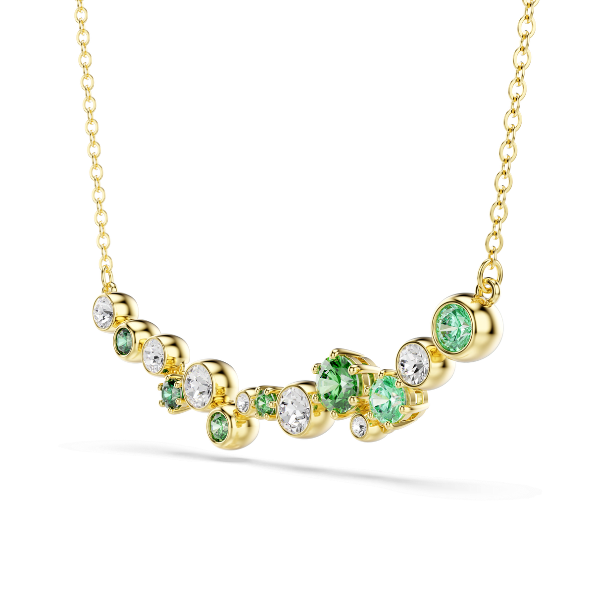 Introducing the Swarovski Constella necklace, a breathtaking piece featuring mixed-cut green and clear Swarovski Zirconia set in a curved pendant with an elegant 18K gold finish. The necklace is displayed on a delicate gold chain against a white background.