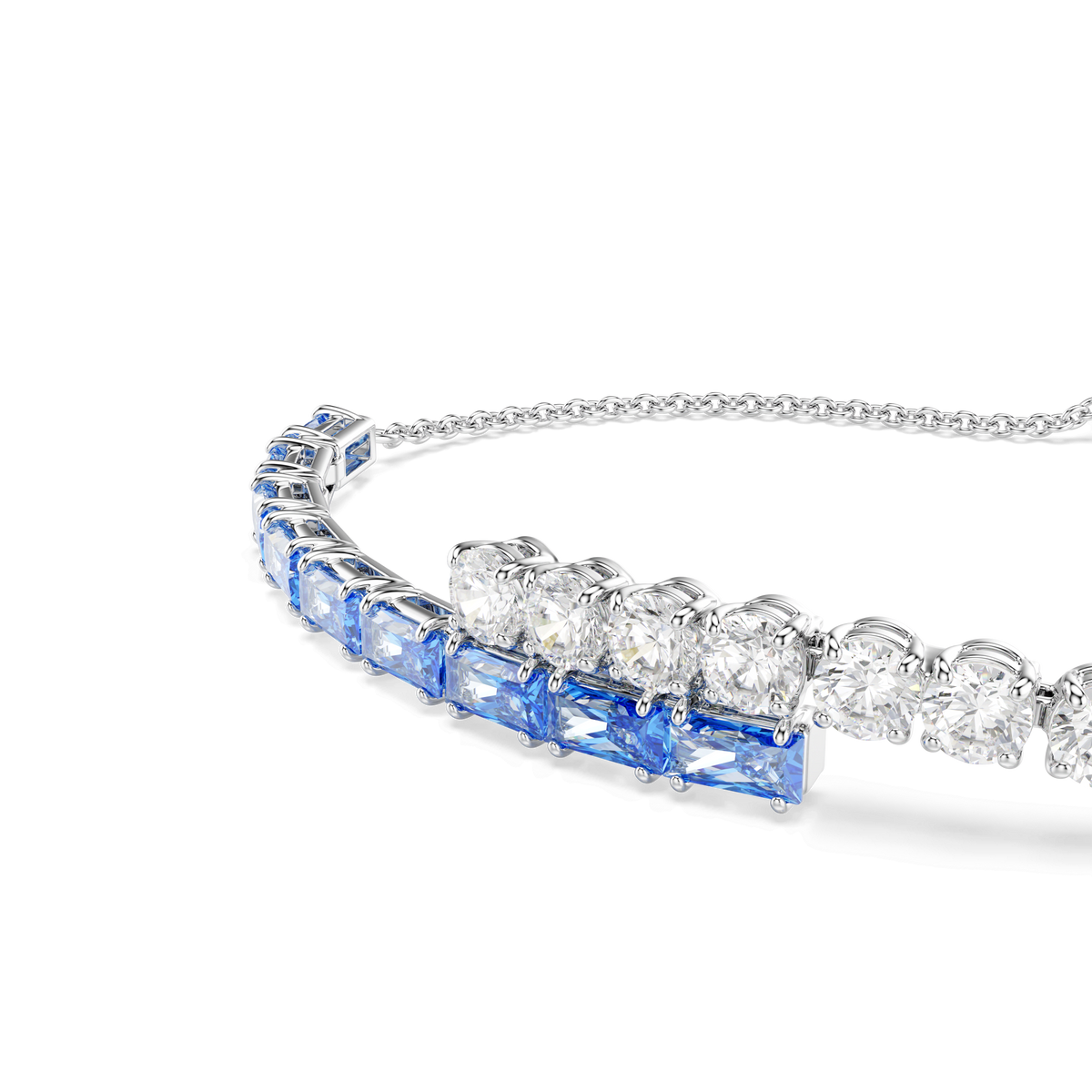 A close-up of the Swarovski Matrix bracelet, featuring alternating blue mixed-cut stones and clear Swarovski Zirconia diamonds set in a single row on a delicate rhodium-plated chain, displayed against a white background.
