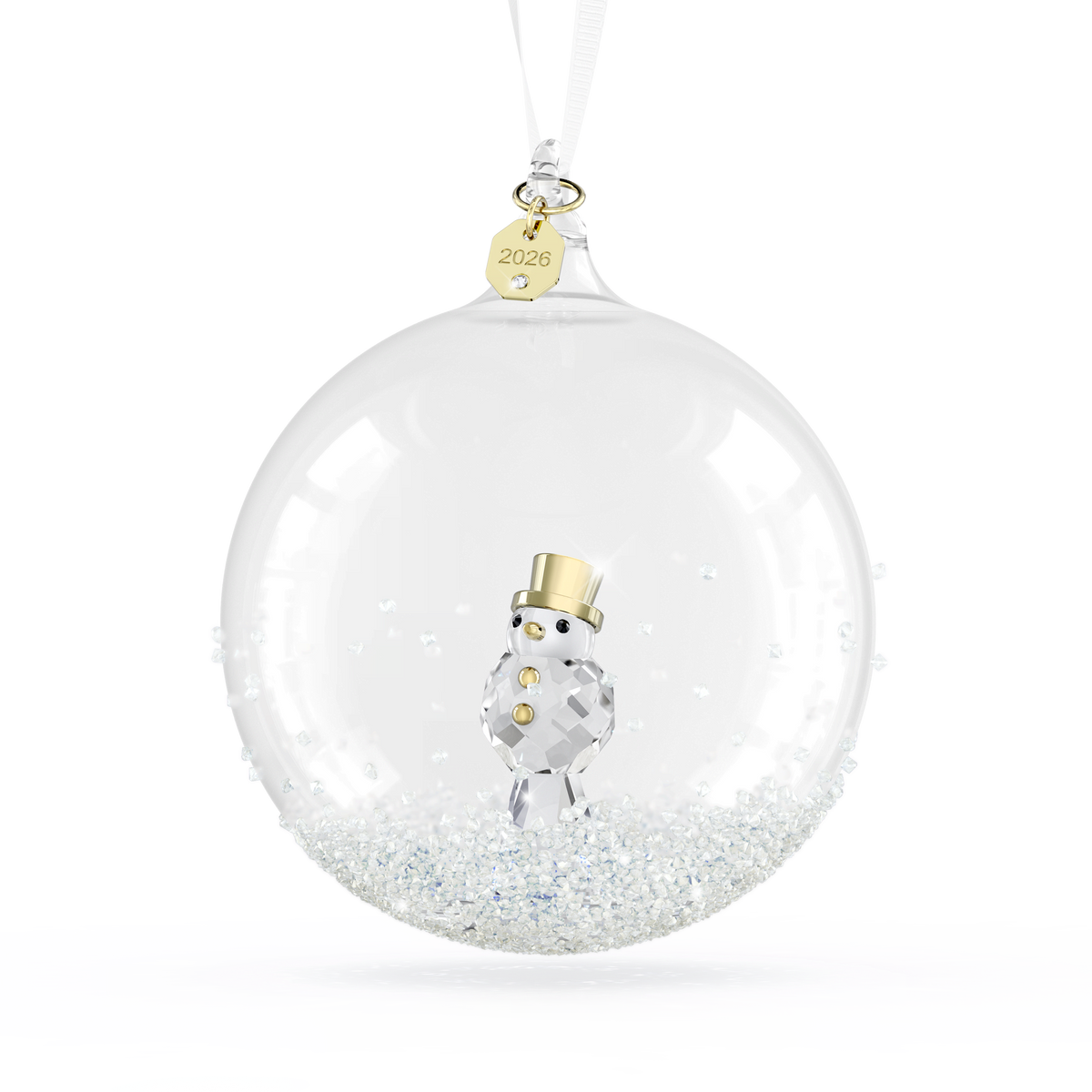 The Swarovski Annual Edition Ball Ornament 2026 by Swarovski features a clear glass design that beautifully encases a small crystal snowman adorned with a gold hat and buttons. Suspended from a white ribbon with a gold tag engraved “2026,” this elegant crystal Christmas ornament is finished with sparkling white crystals scattered at the bottom.