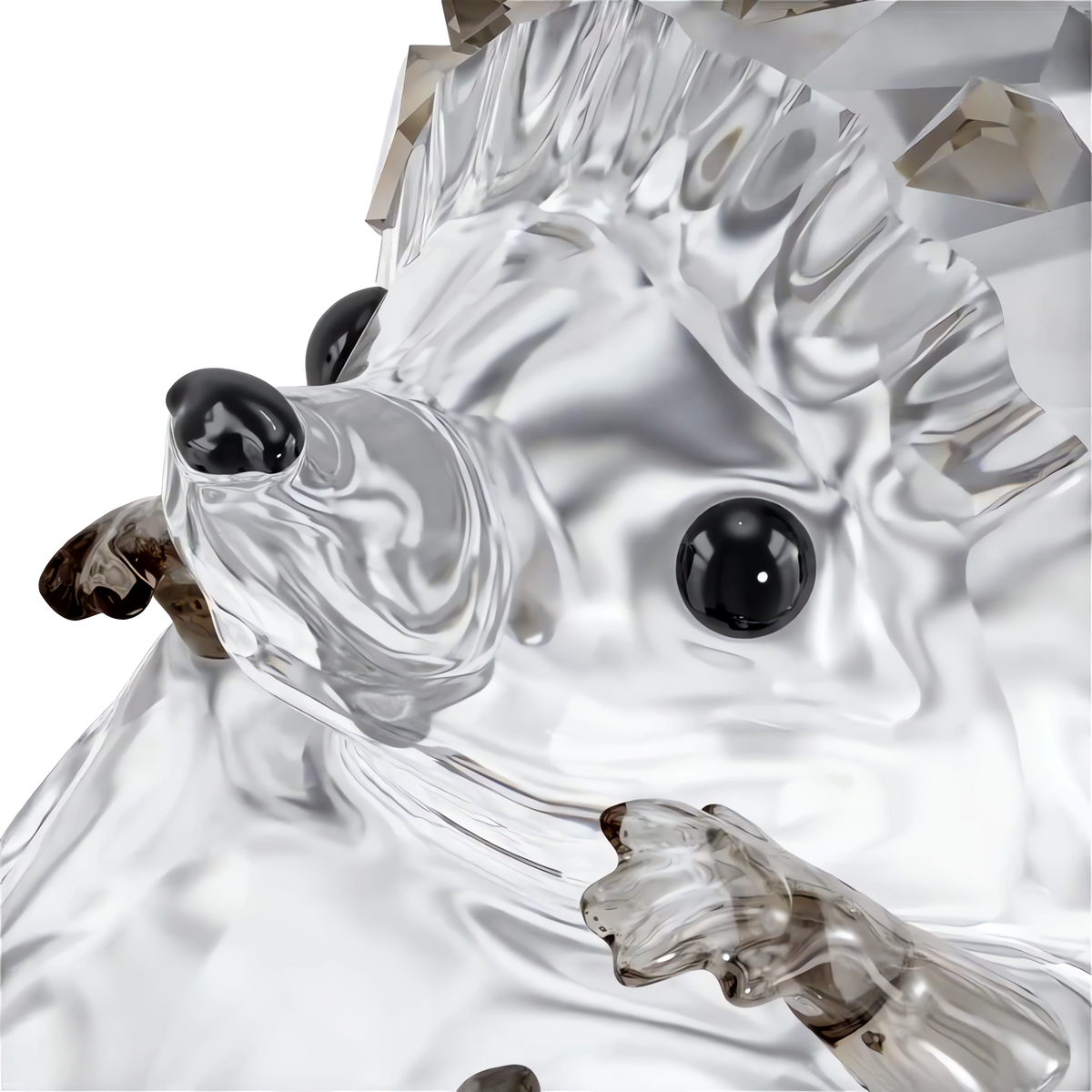 A close-up of the Swarovski Idyllia Hedgehog, a clear crystal figurine by Swarovski featuring black eyes, brown-tinted paws, and textured spikes that capture the essence of a hedgehog, set against a plain white background.