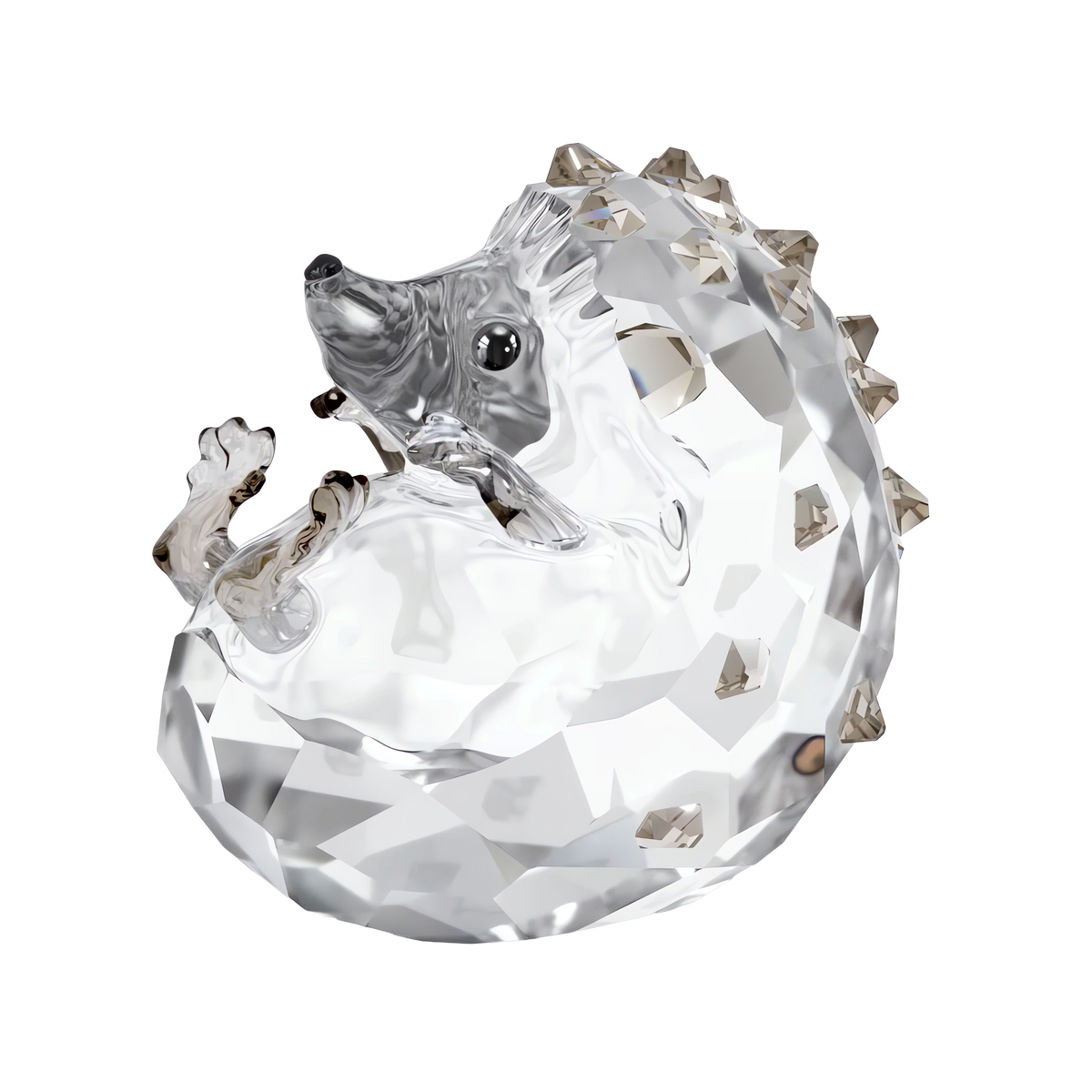 The Swarovski Idyllia Hedgehog by Swarovski features a faceted clear glass body with a curled shape, a pointed snout, small black eyes, and smoky-colored crystal spikes along its back. Set against a white background, this charming figurine artfully captures the whimsical spirit of woodland creatures.