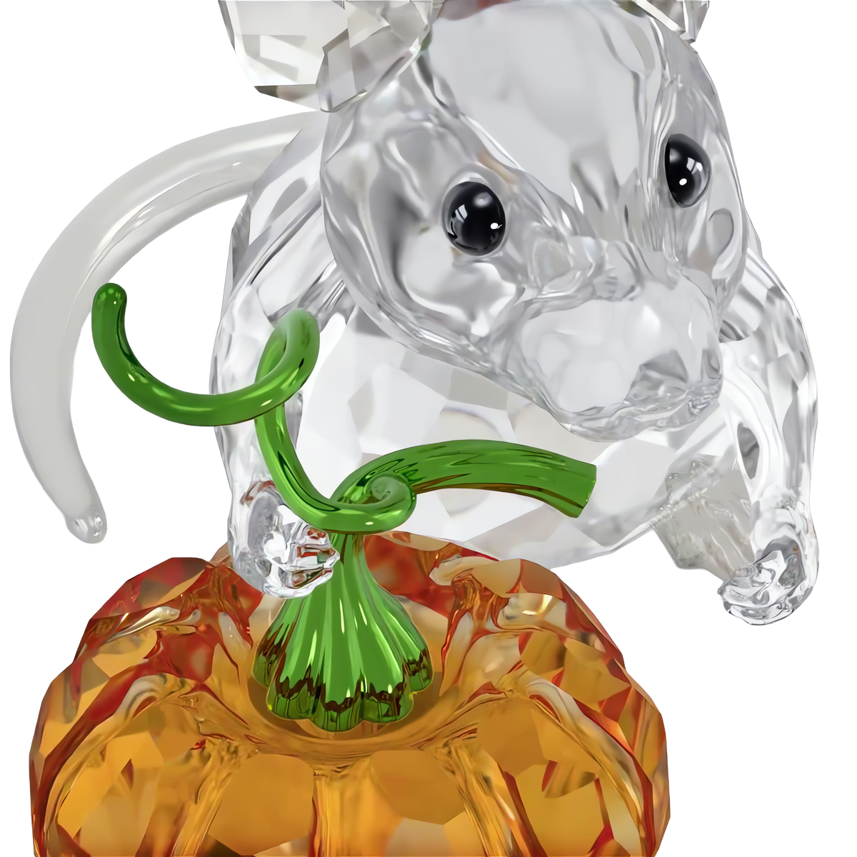 The Swarovski Idyllia Mouse and Pumpkin by Swarovski features a charming crystal mouse figurine with black eyes perched atop an orange pumpkin, complete with green glass leaves and stem, making it a delightful pumpkin decoration for any Halloween display against a white background.