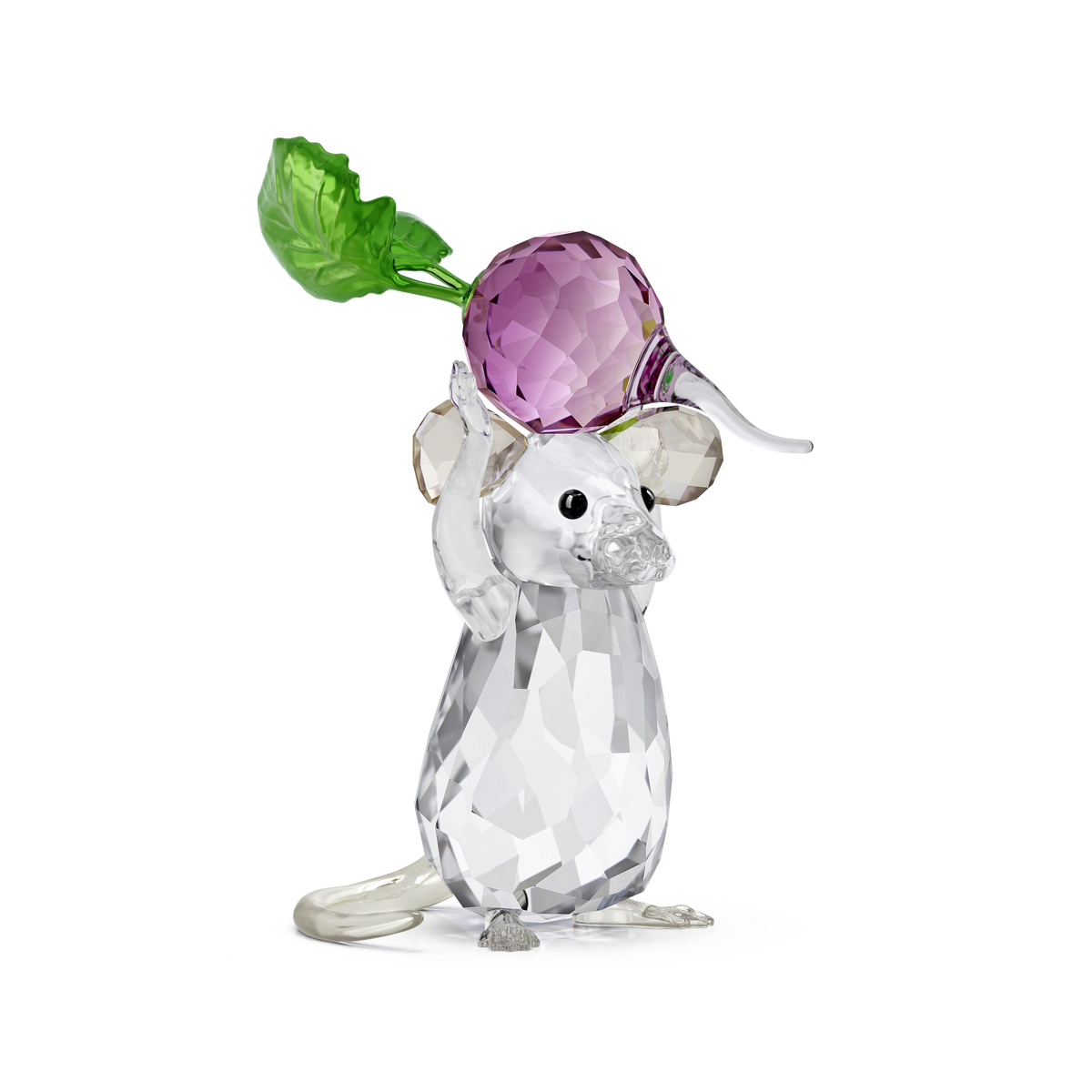 The Swarovski Idyllia Mouse and Radish figurine by Swarovski features a faceted crystal mouse holding a large, purple radish with green leaves above its head, creating a charming crystal decoration against a plain white background.