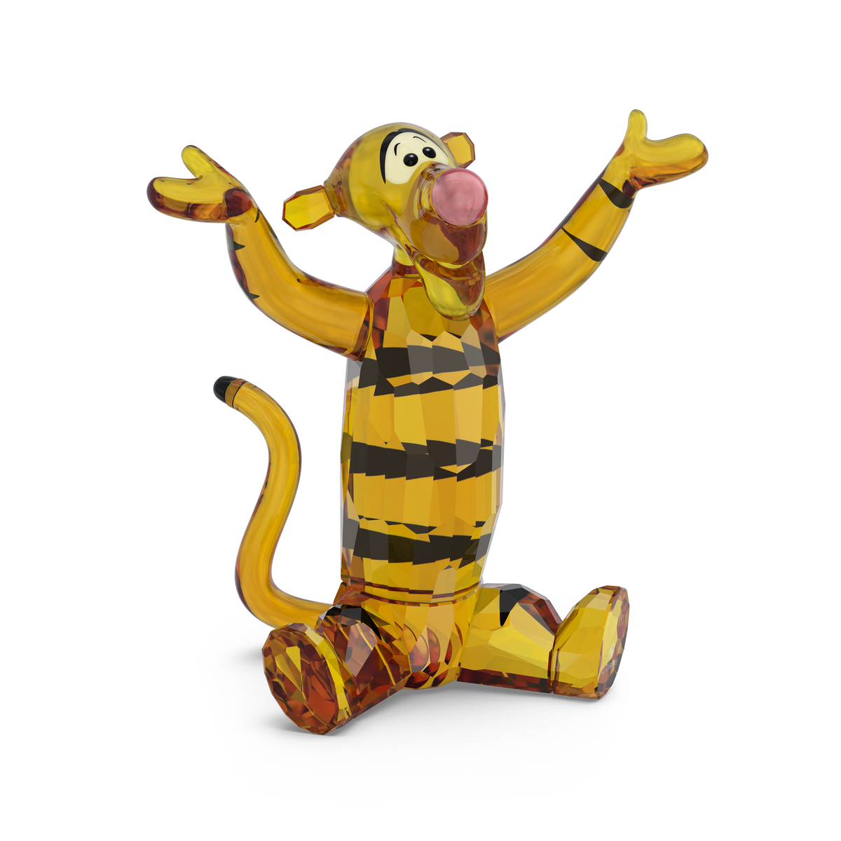 A Swarovski Winnie The Pooh Tigger figurine by Swarovski, featuring faceted yellow and orange crystal, depicts Tigger sitting with arms raised and smiling against a white background.