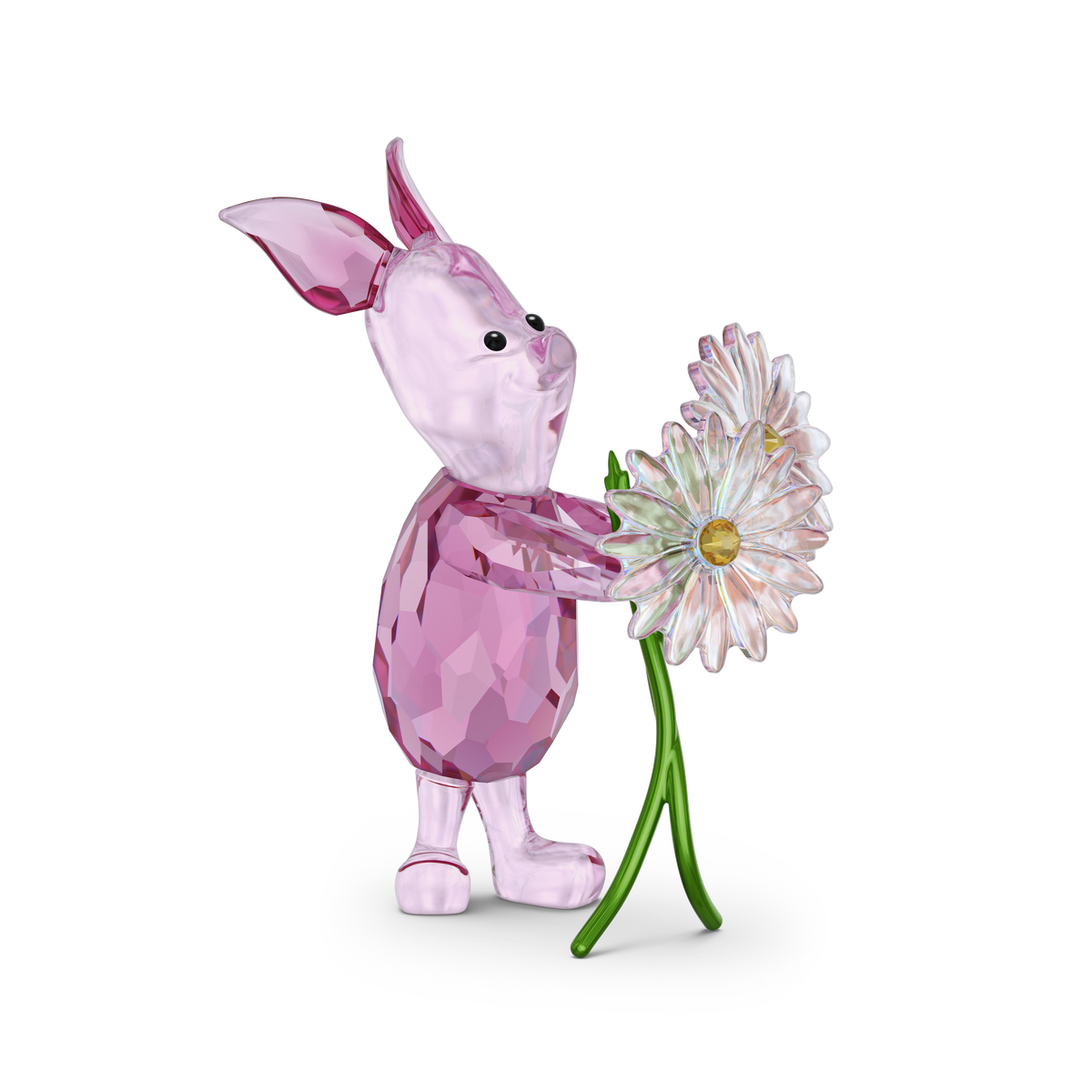 The Swarovski Winnie The Pooh Piglet figurine by Swarovski showcases a delightful pink Piglet holding two white daisies with yellow centers and green stems, inspired by the classic Winnie the Pooh crystal collectibles and set against a plain white background.