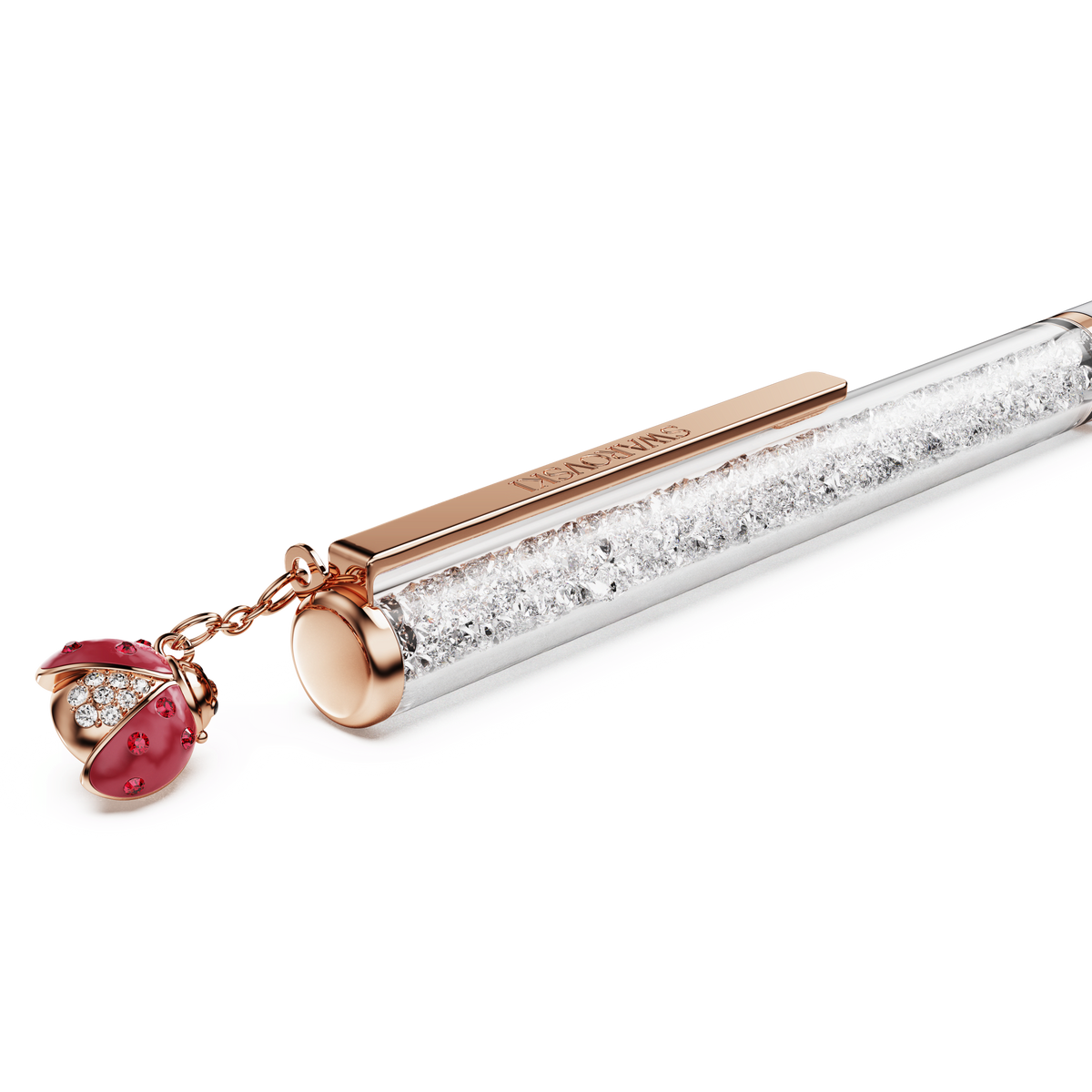 The Swarovski Crystalline ballpoint pen features a rose gold-tone plated clip and is embellished with a pink ladybug charm adorned with crystals, set against a white background.