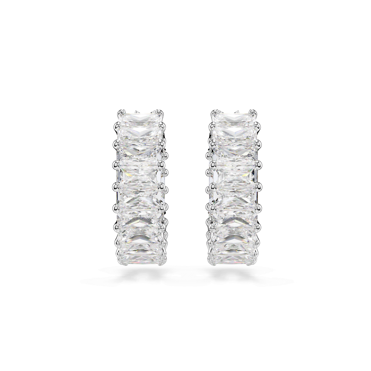The Swarovski Matrix hoop earrings are rhodium plated and feature baguette-cut, white Swarovski Zirconia gemstones arranged in a row, offering a sparkling and elegant design against a plain white background.