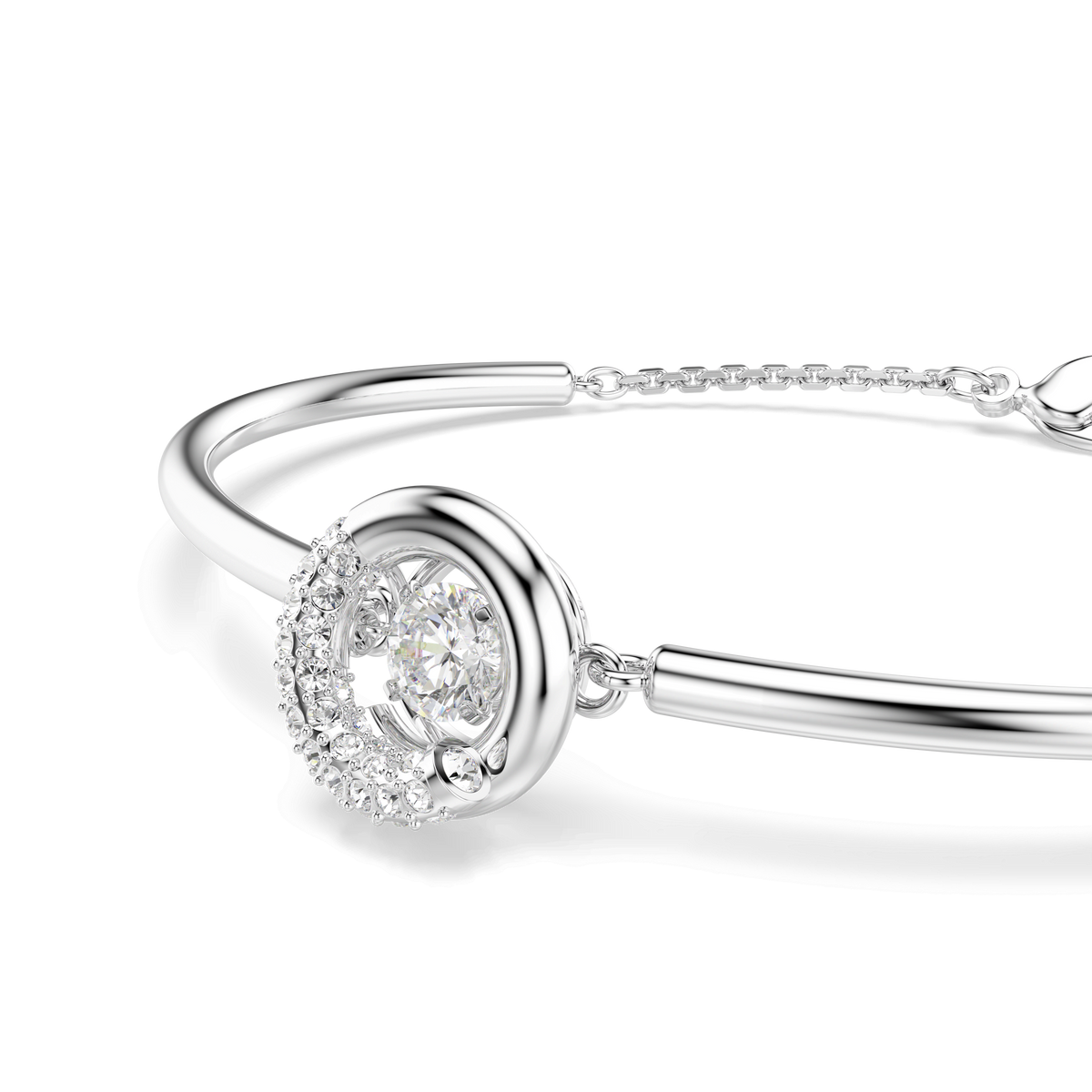 The Swarovski Dextera bangle by Swarovski features a round cut centerpiece adorned with a large central Swarovski Zirconia, surrounded by smaller sparkling stones and finished with rhodium plating, shown on a white background.