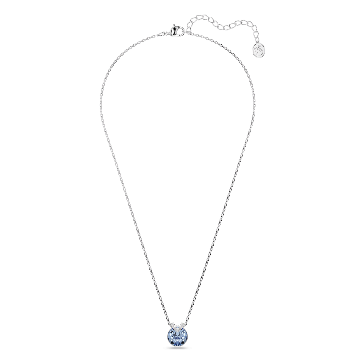 A delicate Swarovski Bella V pendant necklace, featuring a round blue Swarovski crystal in a rhodium-plated setting, is displayed against a plain white background.