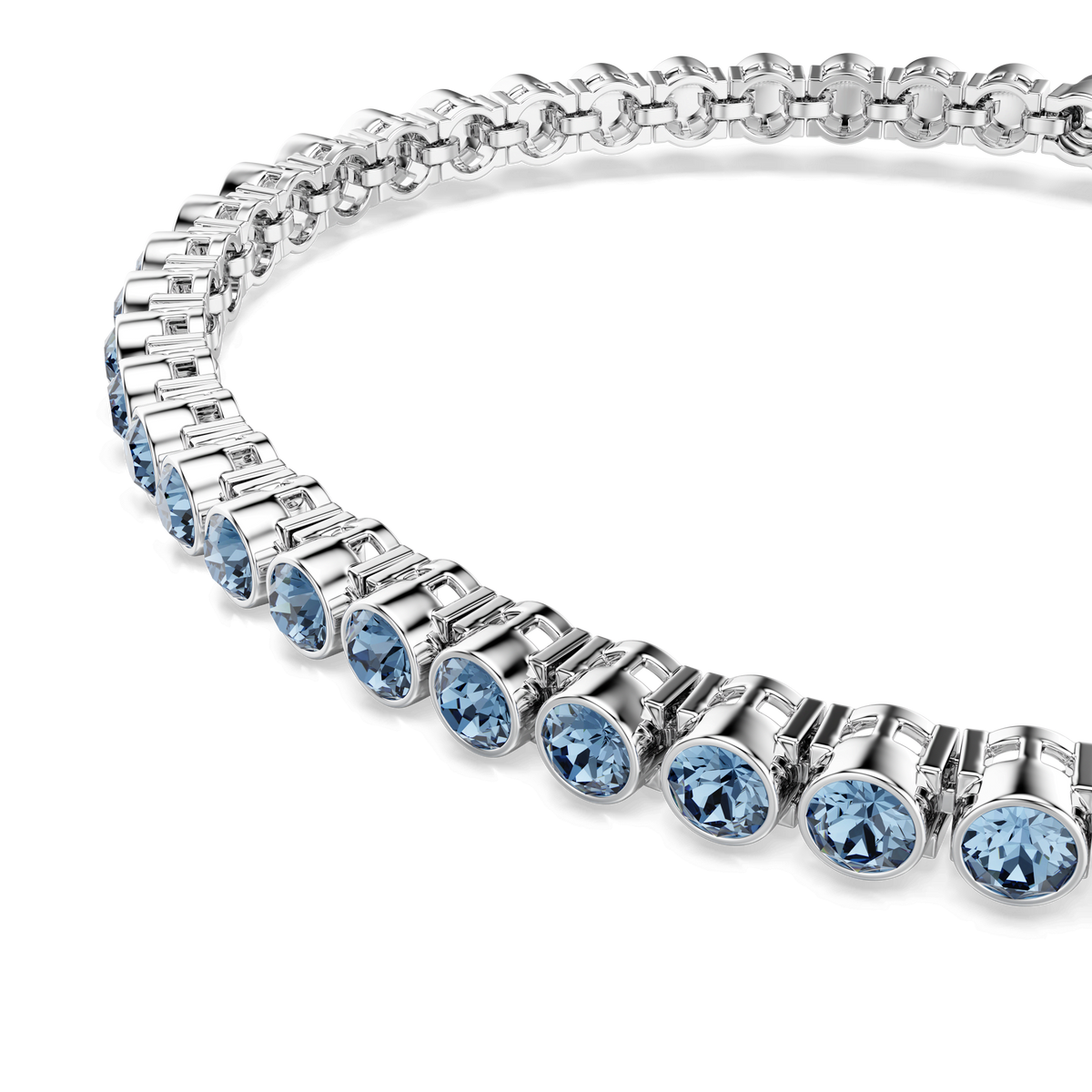 A close-up of a silver necklace featuring round, blue crystals set in individual bezel settings, arranged in a repeating pattern and reminiscent of the elegant style seen in the Swarovski Imber Emily Tennis bracelet, featuring round cut blue stones and rhodium plating.