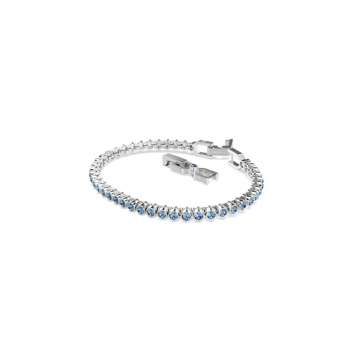 A Swarovski Imber Emily Tennis bracelet, rhodium plated and adorned with round blue crystals, is displayed on a white background with its clasp visible.