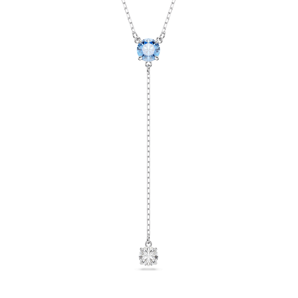 The Swarovski Stilla Attract Y necklace showcases a round-cut blue gemstone and a clear gemstone in a vertical, rhodium-plated drop design, set against a white background.
