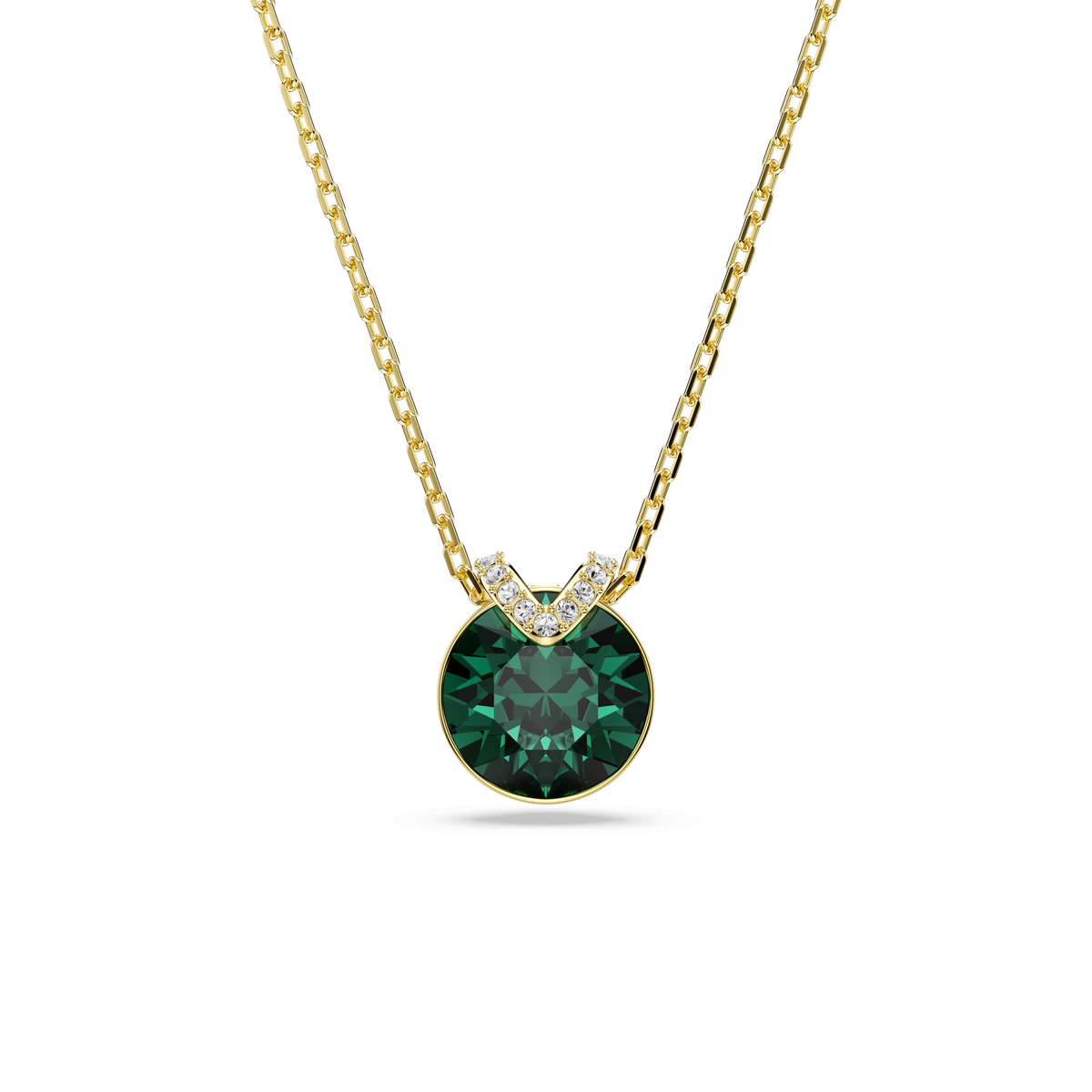 A Swarovski Bella V pendant featuring a round cut green gemstone, accented by small clear stones at the top, is showcased on a simple gold-tone plated chain against a white background. Inspired by timeless sophistication and crafted with the renowned quality of Swarovski, this piece embodies elegant design in every detail.