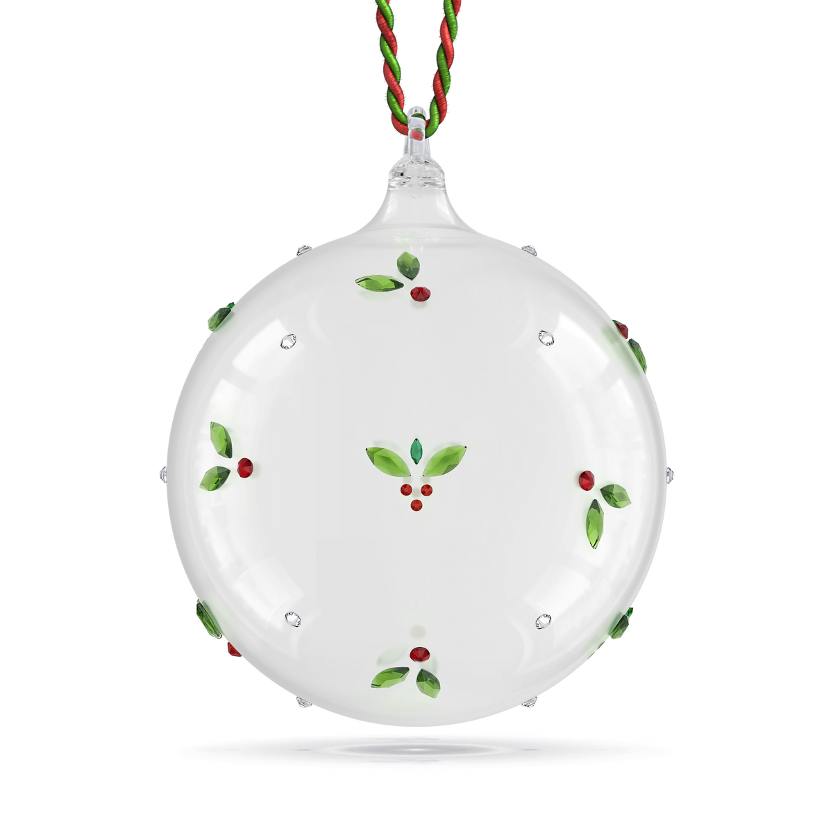 The Swarovski Holiday Cheers Mistletoe Ball Ornament by Swarovski is a round, clear glass ball adorned with a nature-inspired design of delicate green holly leaves and red berries, and hangs elegantly from a red and green twisted string.