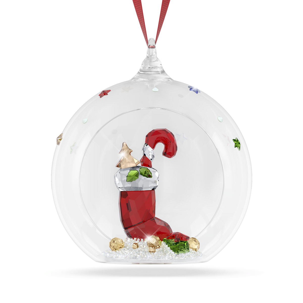 The Swarovski Holiday Cheers Stocking and Candy Ball Ornament by Swarovski is a clear glass ornament adorned with a red ribbon, showcasing a red Christmas stocking, a small dog wearing a Santa hat, holly, and elegant gold accents inside—making it the perfect festive decoration for your tree.