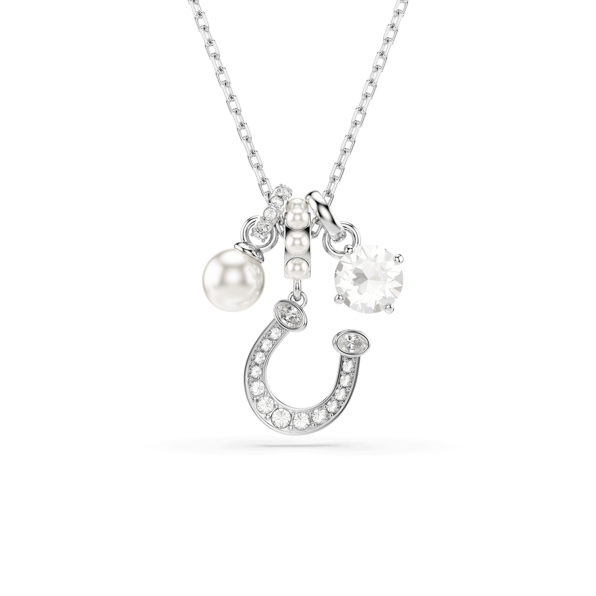 The Swarovski Symbolica Pendant features a rhodium-plated horseshoe adorned with pavé crystals, a lustrous crystal pearl, and a sparkling round-cut clear stone, all elegantly suspended from a delicate chain against a plain white background.