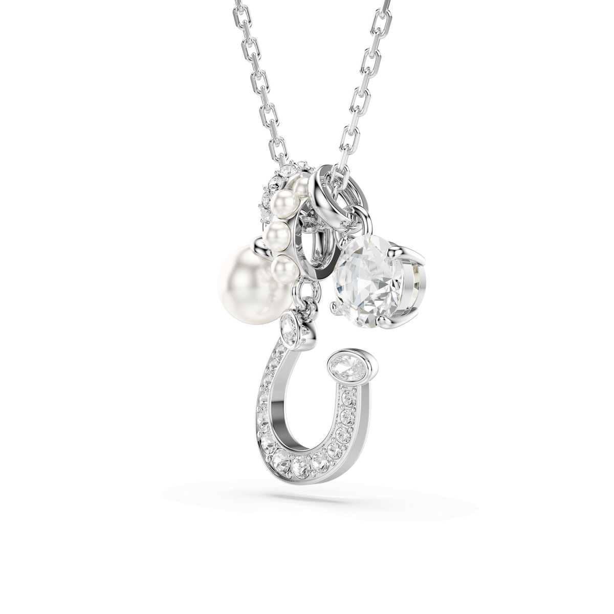 Introducing the Swarovski Symbolica pendant: a rhodium-plated necklace featuring a sparkling pavé horseshoe, a round-cut white gemstone, and an elegant Swarovski Crystal Pearl—all suspended from a delicate chain.