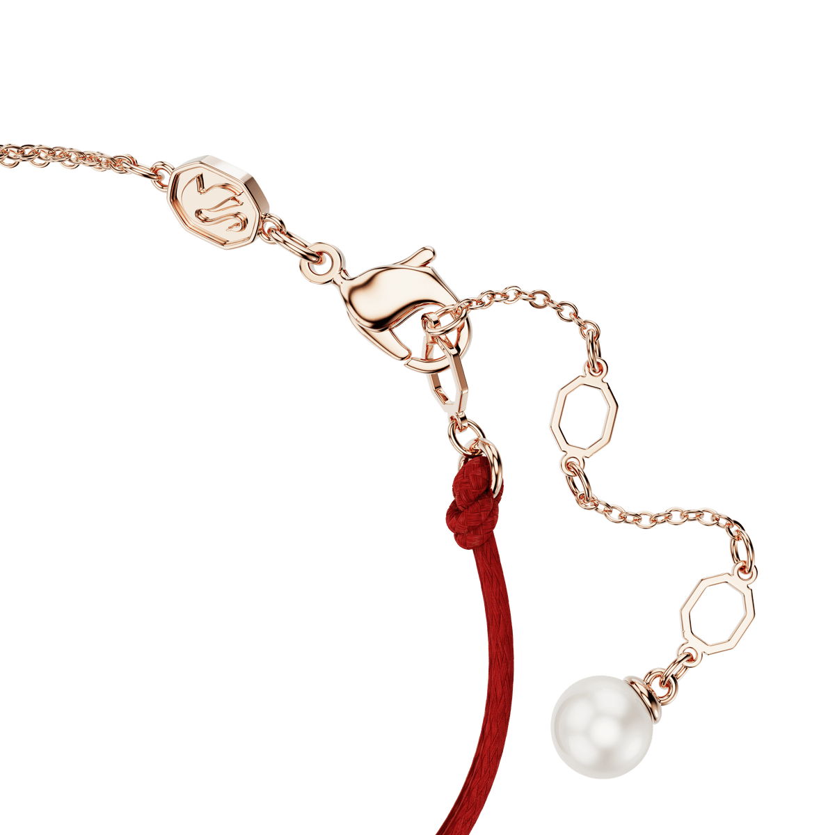 A close-up of the Swarovski Symbolica bracelet, featuring a single white Swarovski Crystal Pearl charm, pavé detailing, and a horseshoe motif on an 18K rose gold-finished chain with hexagonal links and a red cord, showcased against a white background.