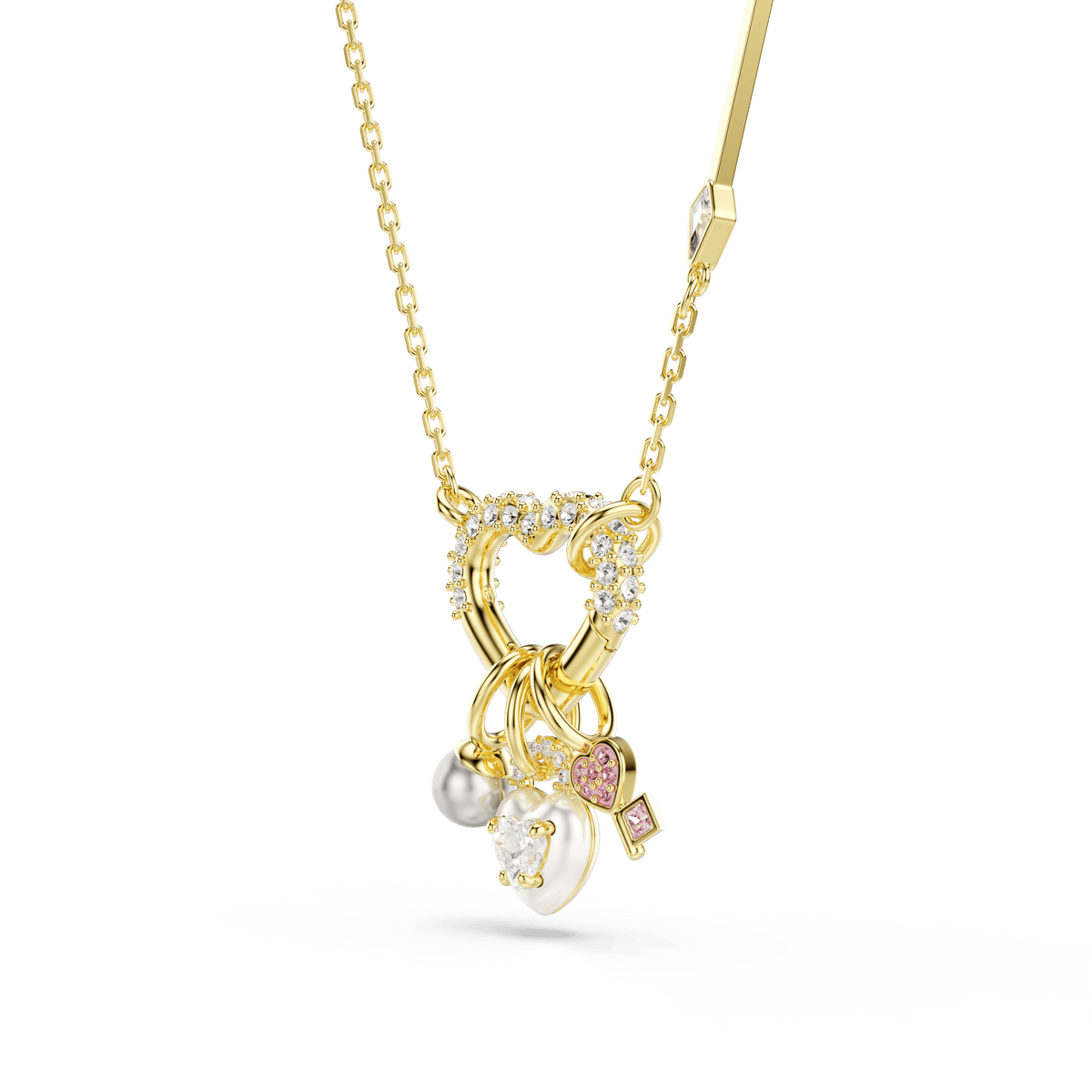 Swarovski Idyllia pendant in an 18K gold finish, featuring a decorative cluster of mixed-cut sparkling white stones, a Swarovski Crystal Pearl, a pink gemstone, and small heart and key charms—all elegantly suspended together.
