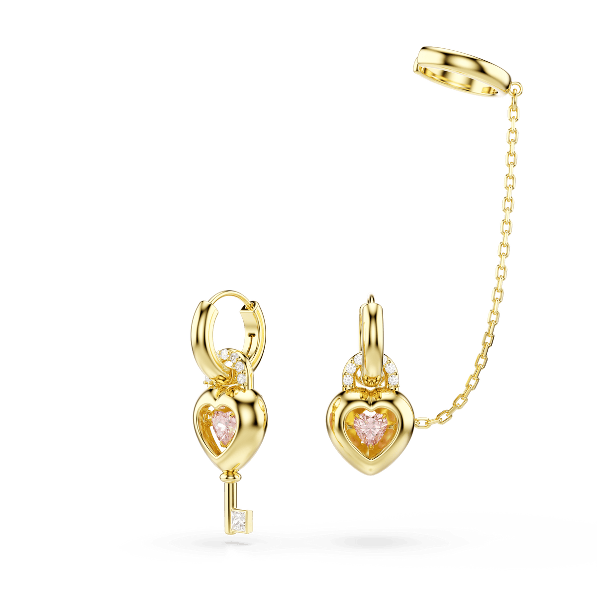 Swarovski Idyllia drop earrings with ear cuff feature mixed-cut designs in 18K gold finish—one shaped like a key with a pink heart and small square gem, the other a matching heart-shaped locket, elegantly linked by a chain to a simple gold ear cuff.