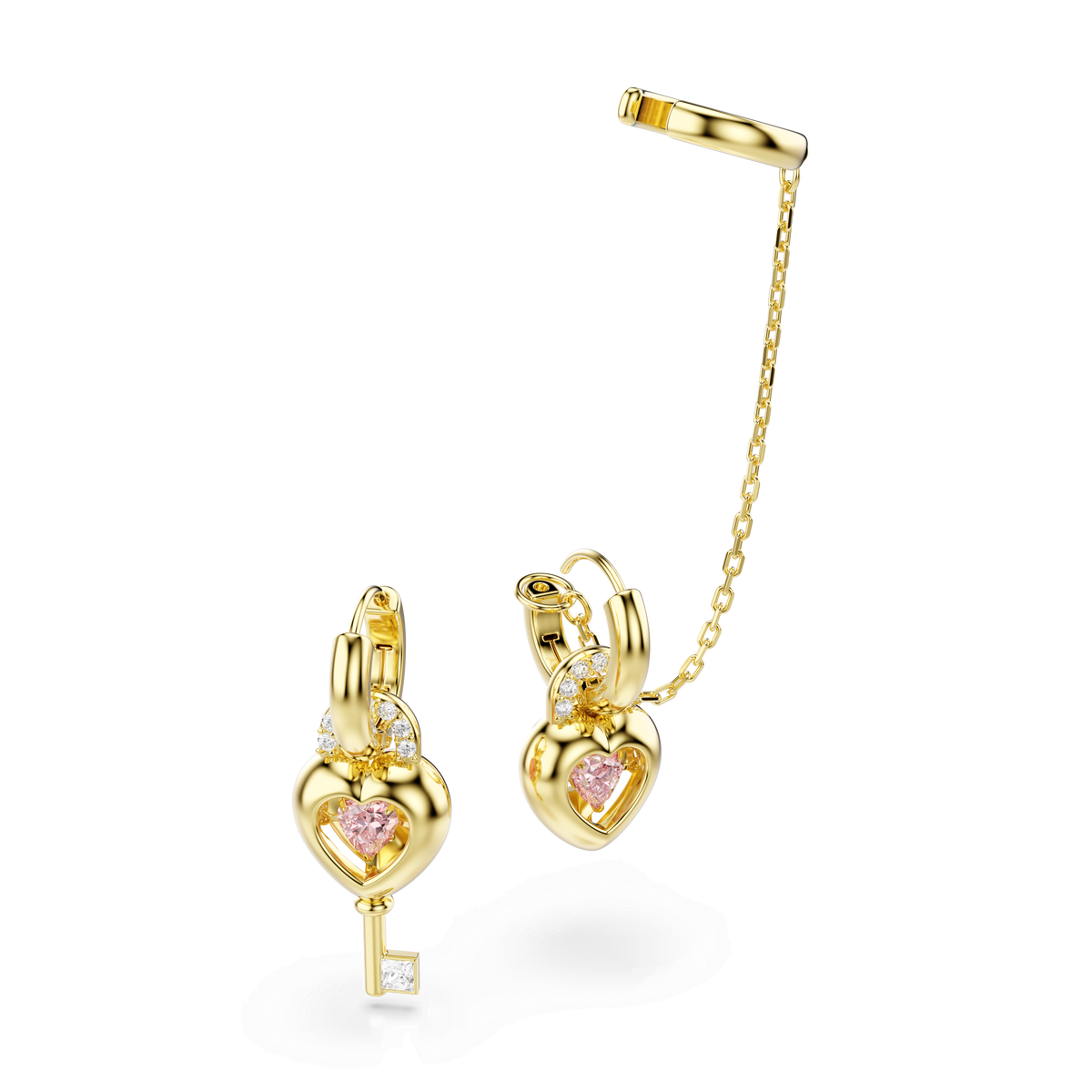 Swarovski Idyllia drop earrings with an ear cuff feature pink heart-shaped stones, mixed-cut clear crystals, and a dangling key charm. One earring is attached to a cuff by a delicate 18K gold-finished chain.